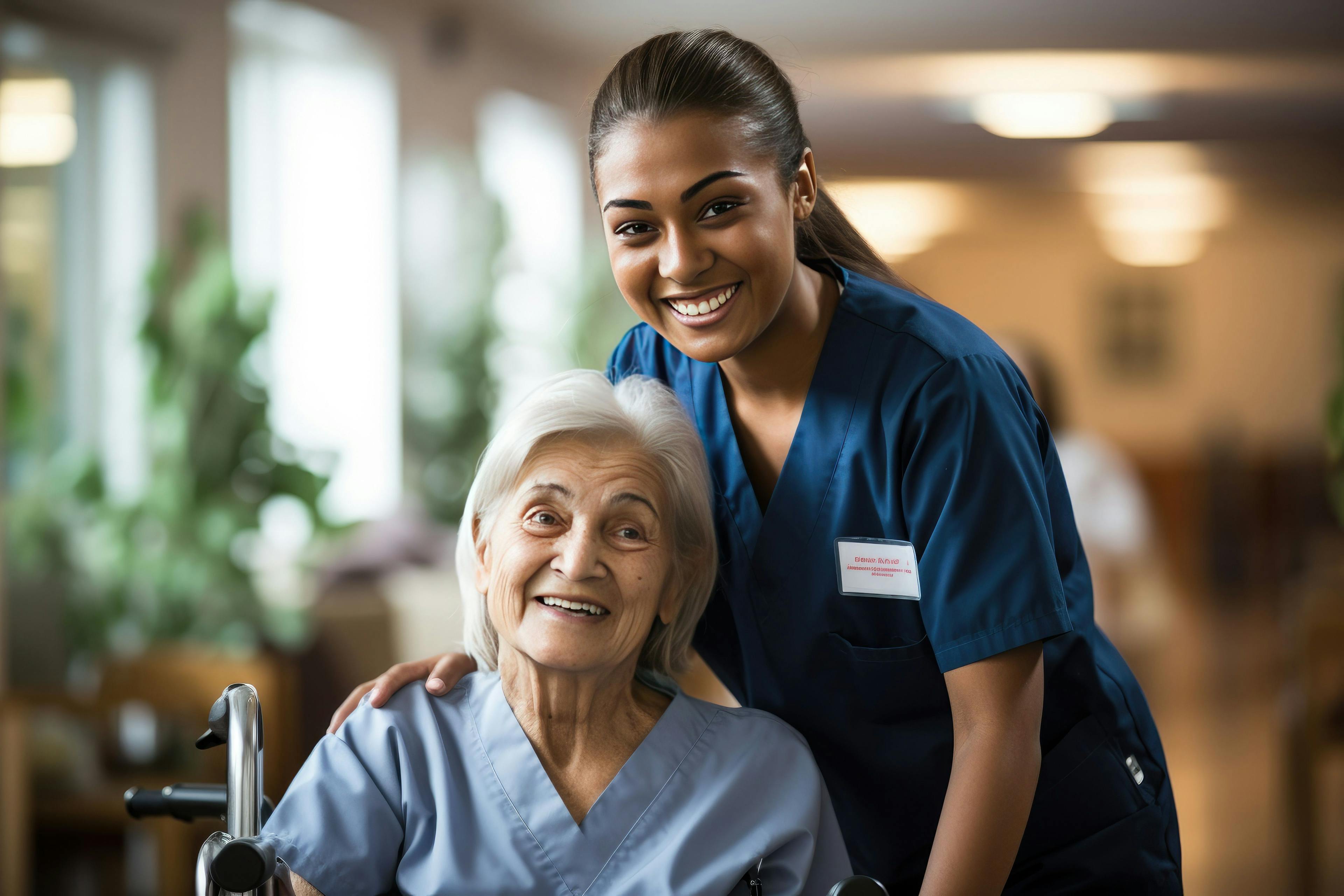 Senior woman and her female caretaker in a nursing home smiling