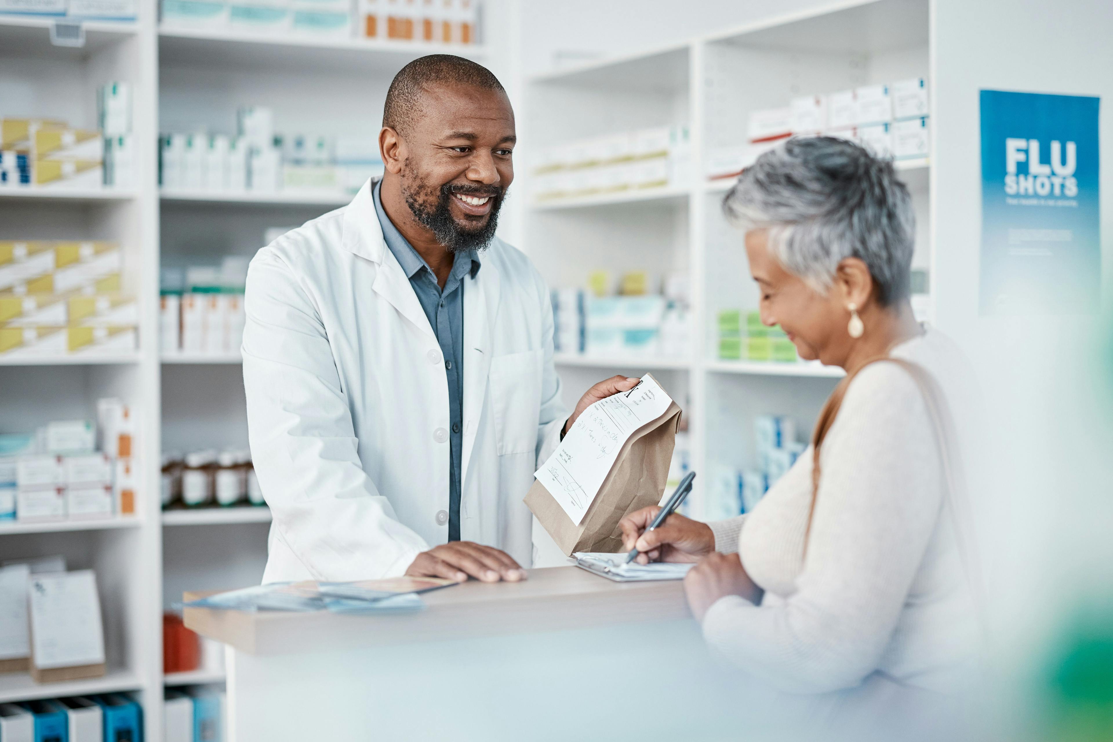 Pharmacist handing a patient their prescription
