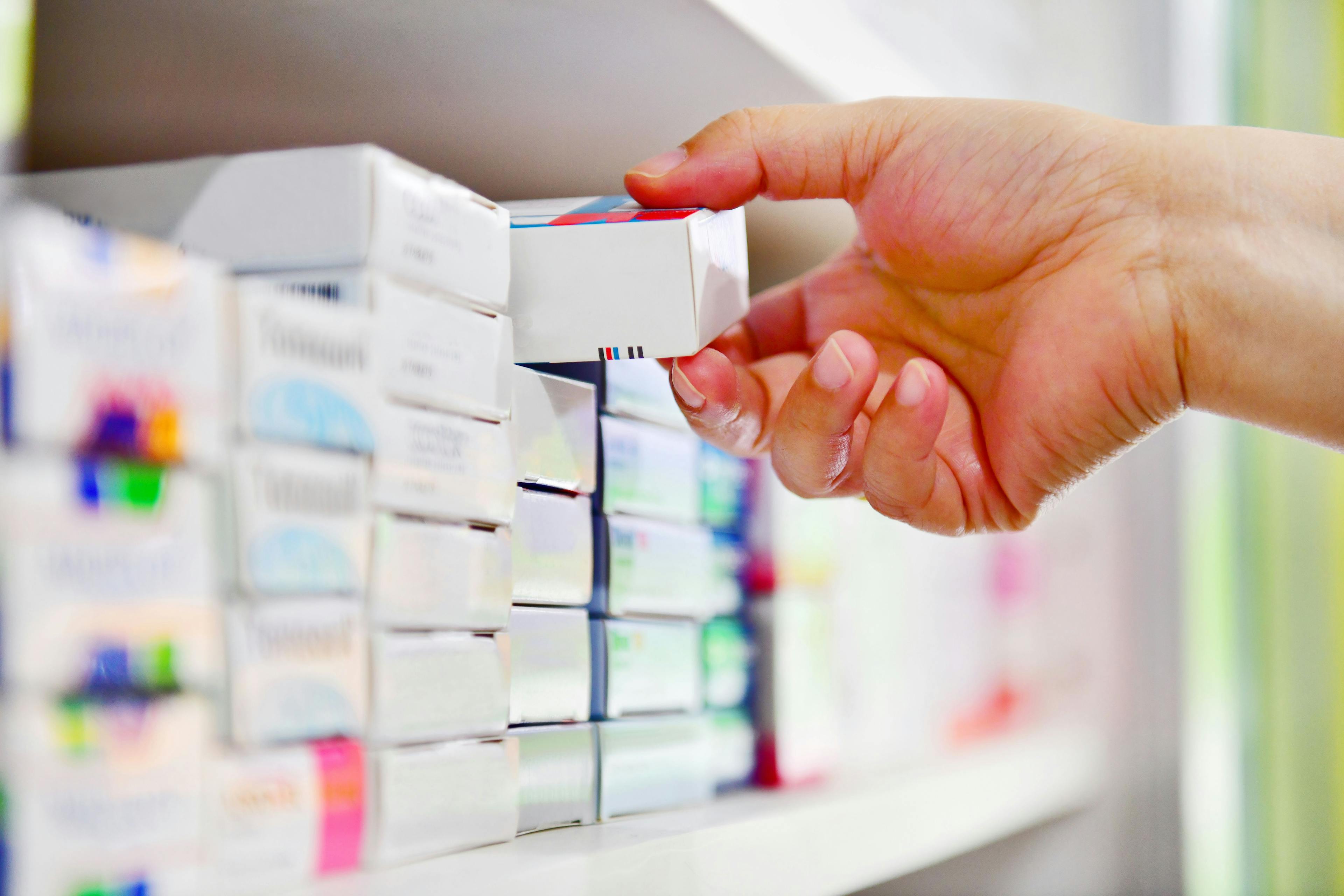 Closeup of pharmacist's hand holding medicine box -- Image credit: I Viewfinder | stock.adobe.com
