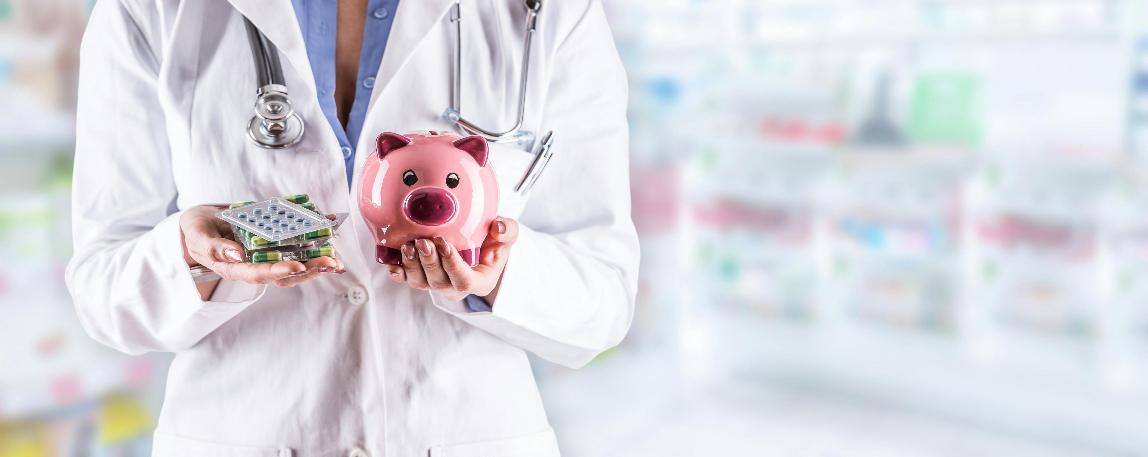 Pharmacist woman hands holding pills and piggy bank. Blurred pharmacy interior in the background