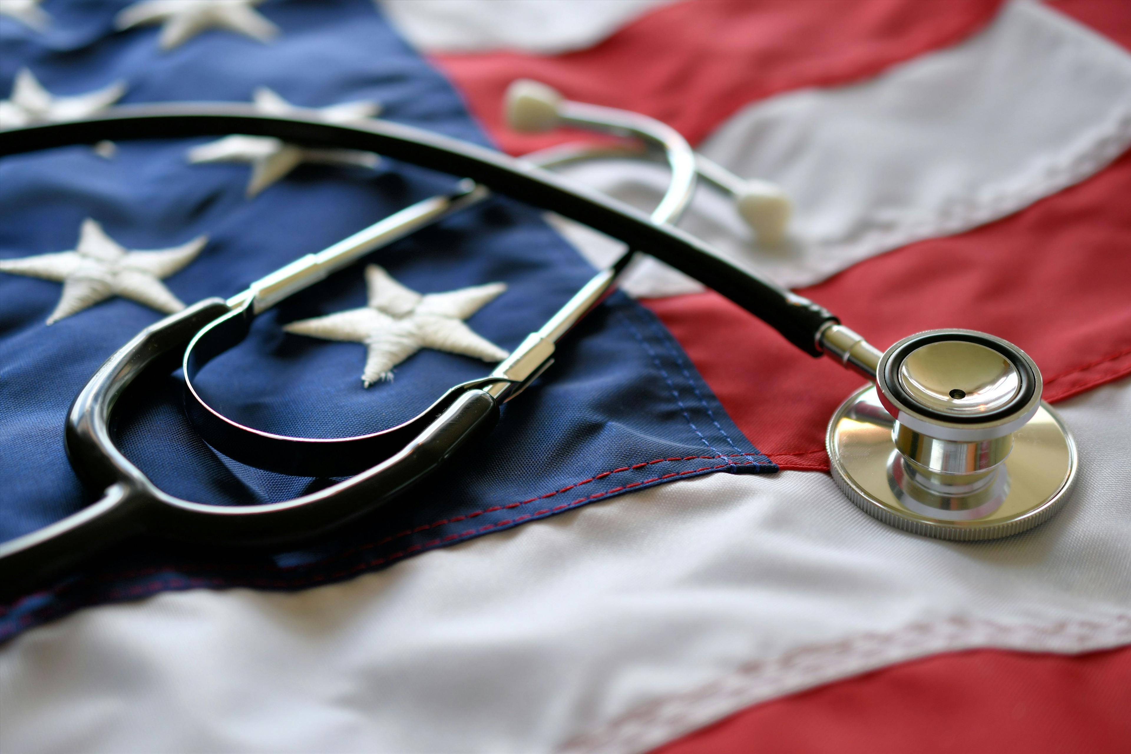 United States America healthcare medical concept - stethoscope on American flag - Image credit: MargJohnsonVA | stock.adobe.com