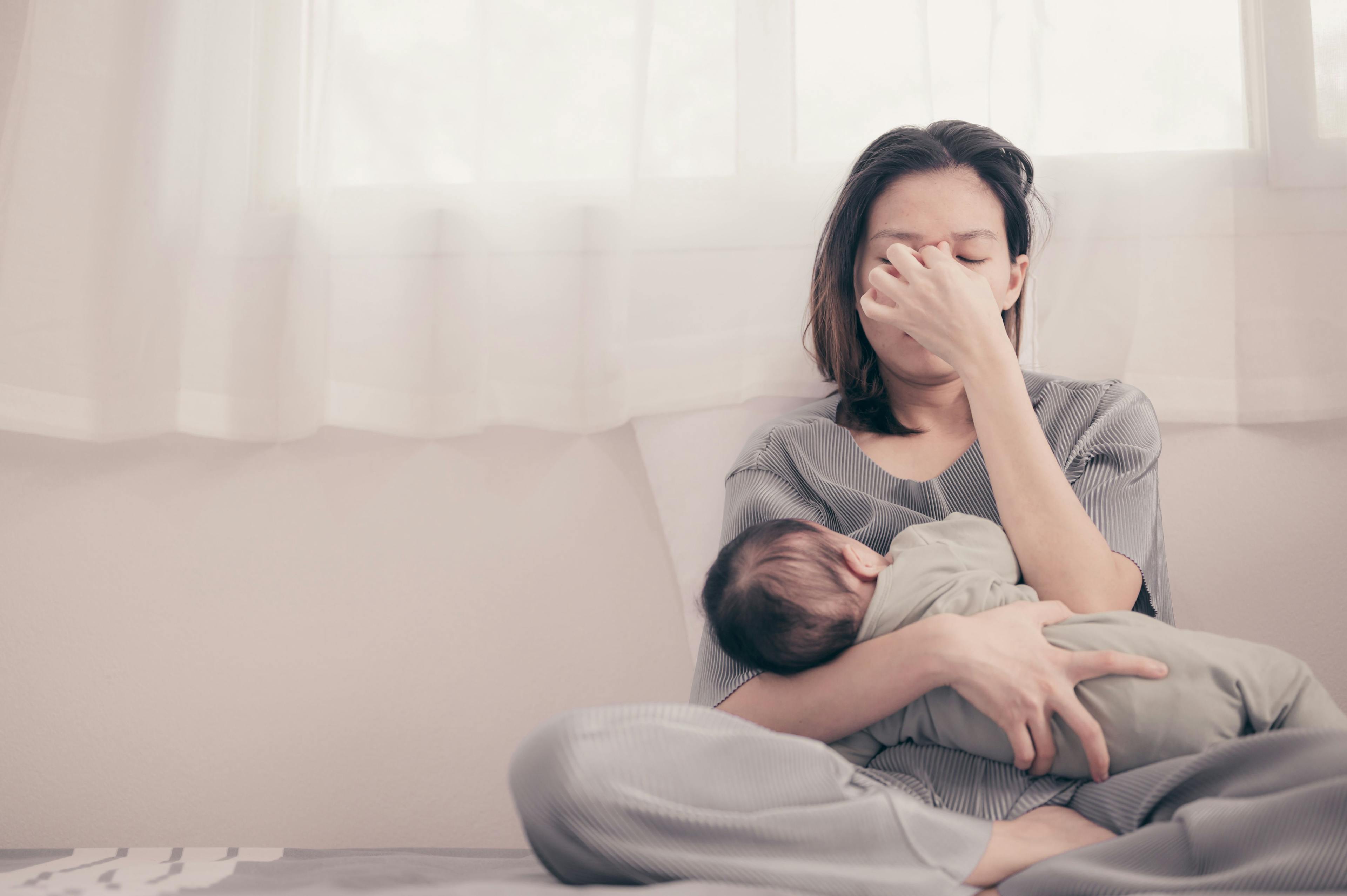 Tired Mother Suffering from experiencing postnatal depression.Health care single mom motherhood stressful - Image credit: grooveriderz | stock.adobe.com