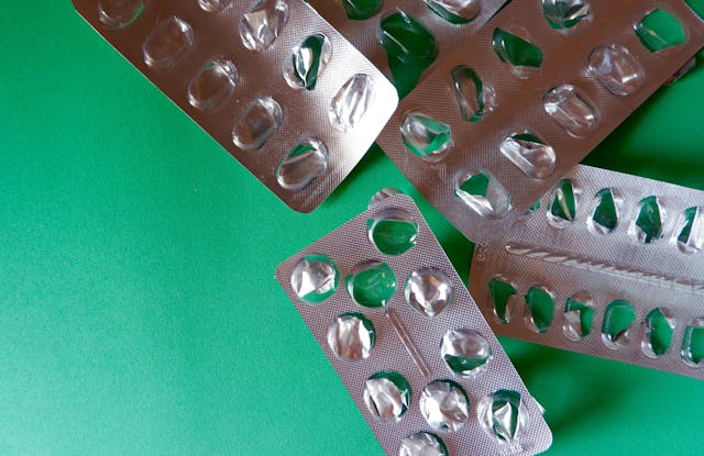 Empty pill blisters on green background. Concepts of medical care, lack of medications, cure - Image credit: Yana Demenko | stock.adobe.com