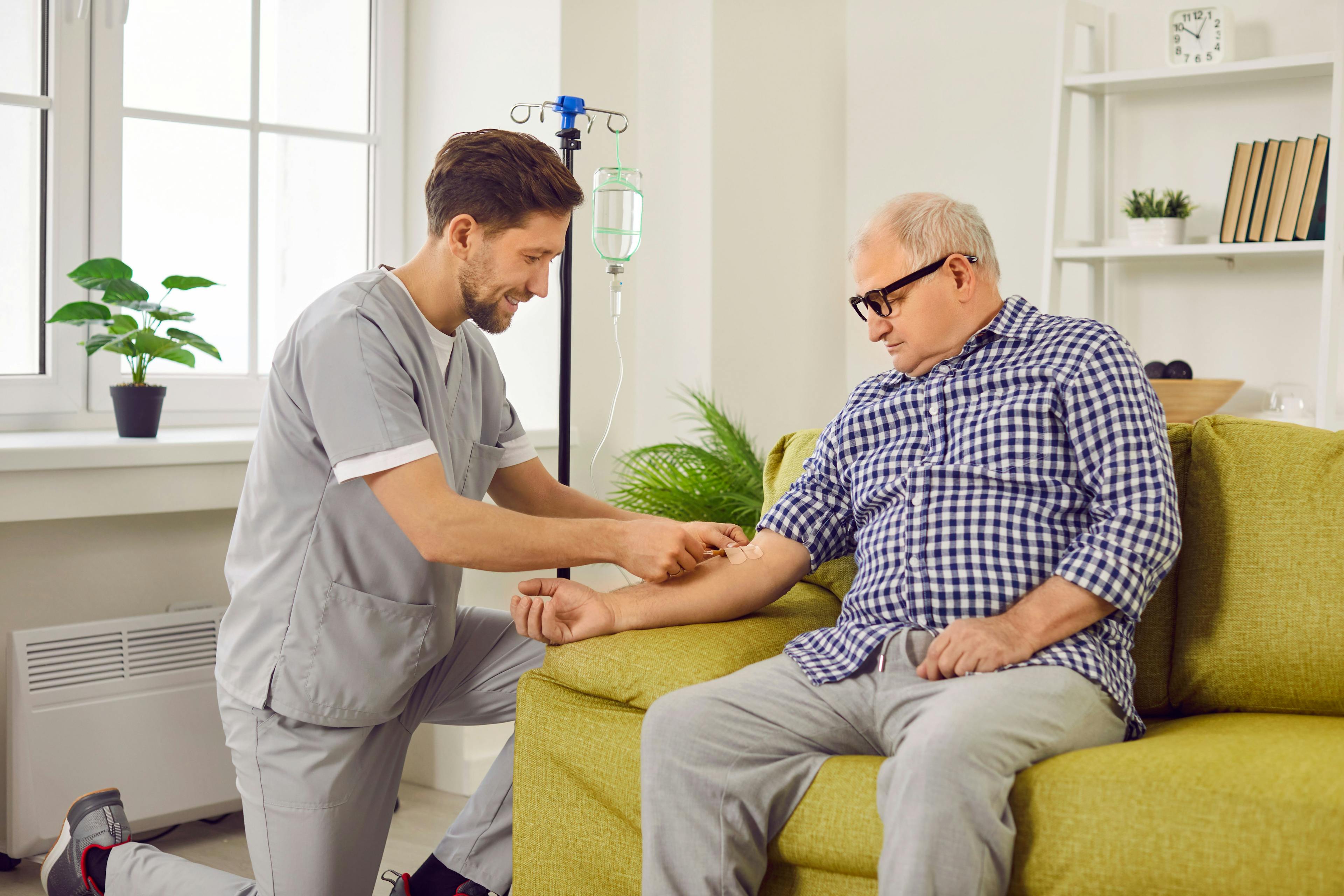Nursing giving infusion to senior patient | Image credit: Studio Romantic - stock.adobe.com