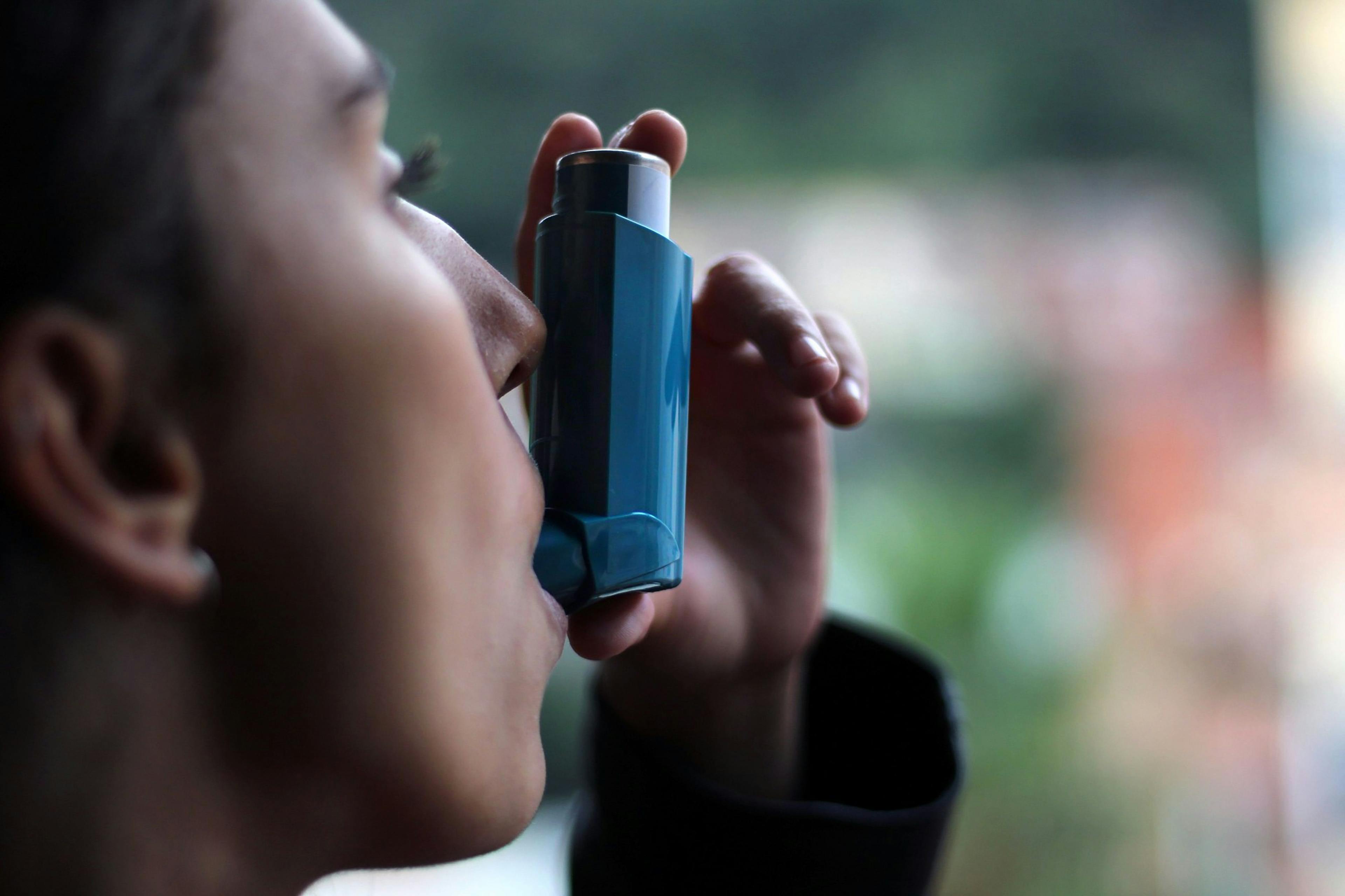 Health and medicine - Young girl using blue asthma inhaler to prevent an asthma attack. - Image credit: DALU11 | stock.adobe.com