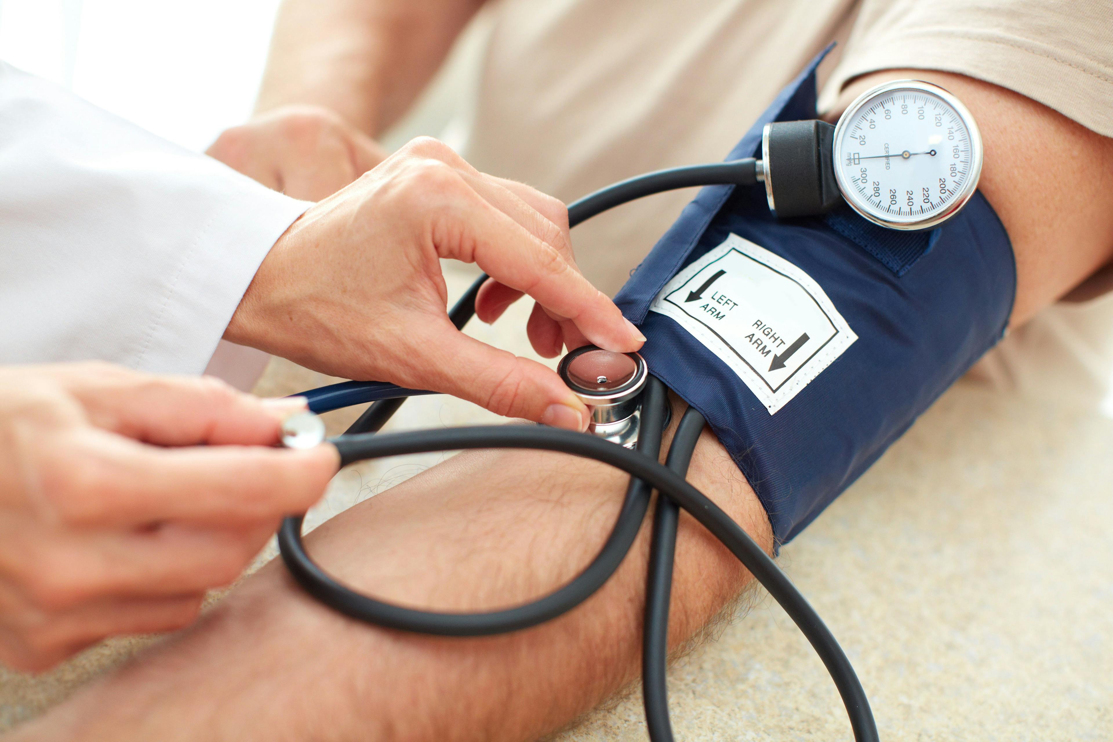 Physician measuring a patient's blood pressure, blood pressure cuff, hypertension