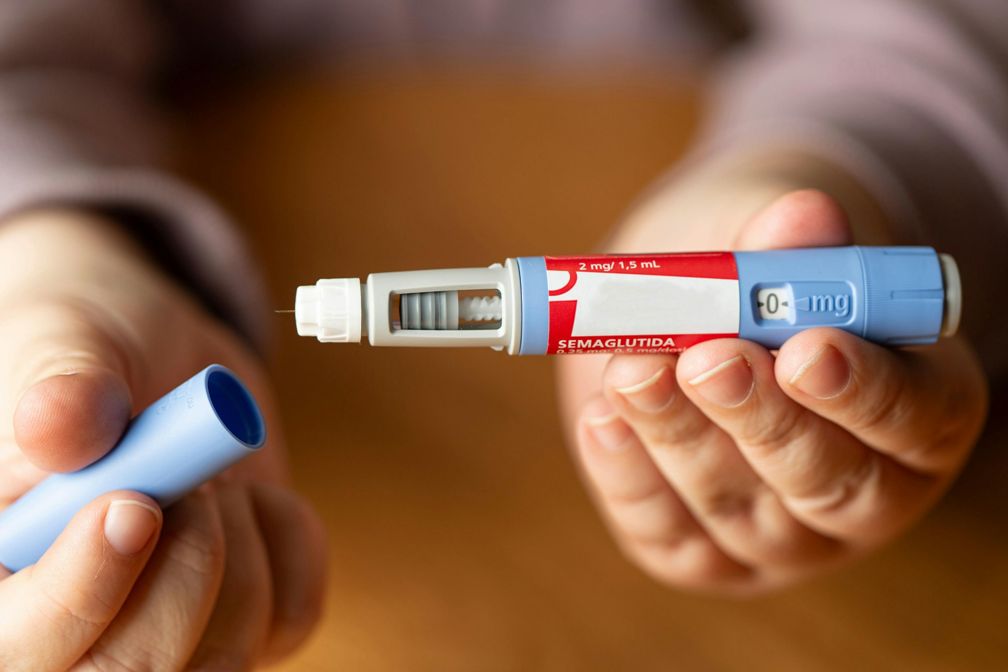person holding a semaglutide injection pen for diabetes and weight loss
