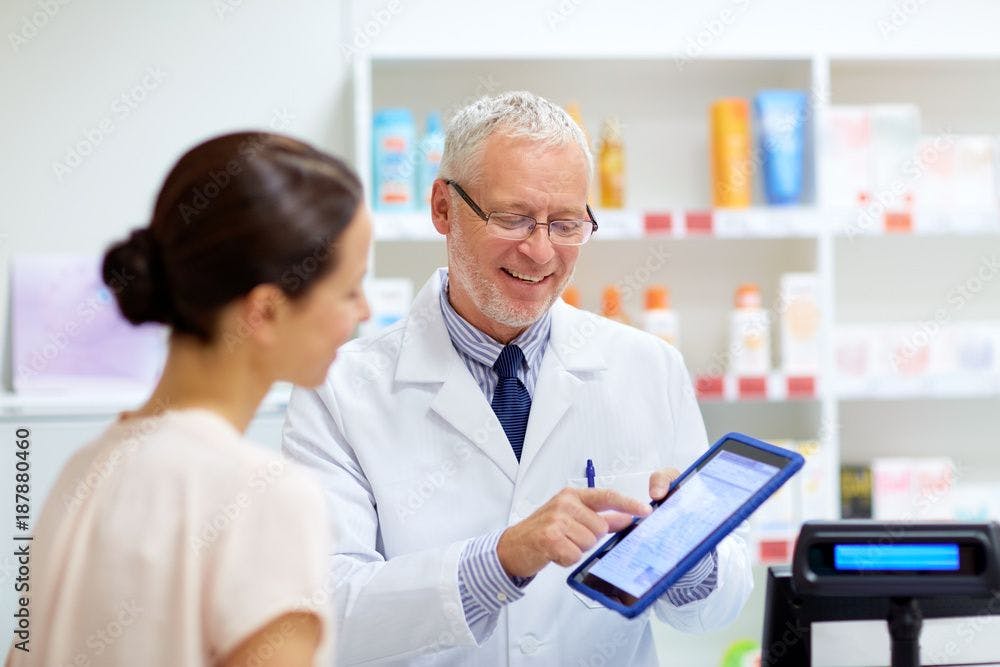 apothecary and customer with tablet pc at pharmacy | Image Credit: Syda Productions - stock.adobe.com