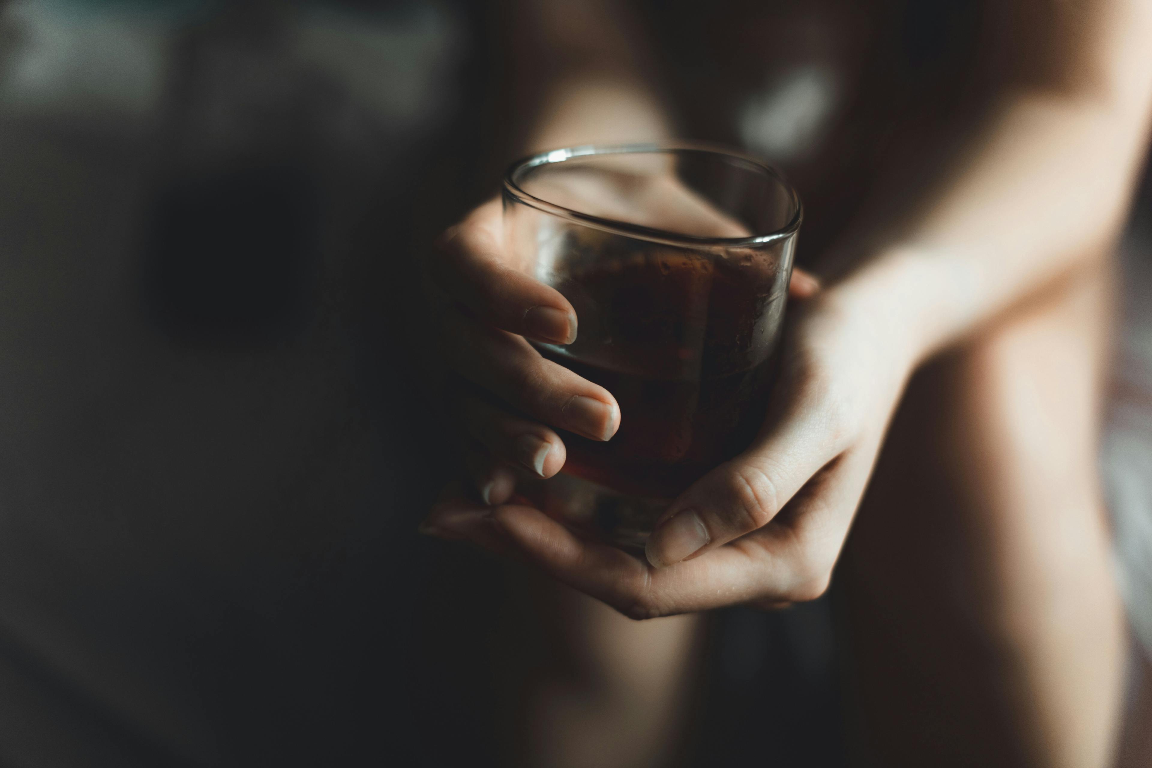 woman's hand with alcohol drink in glass with copy space - Image credit: Danil Nikonov | stock.adobe.com 