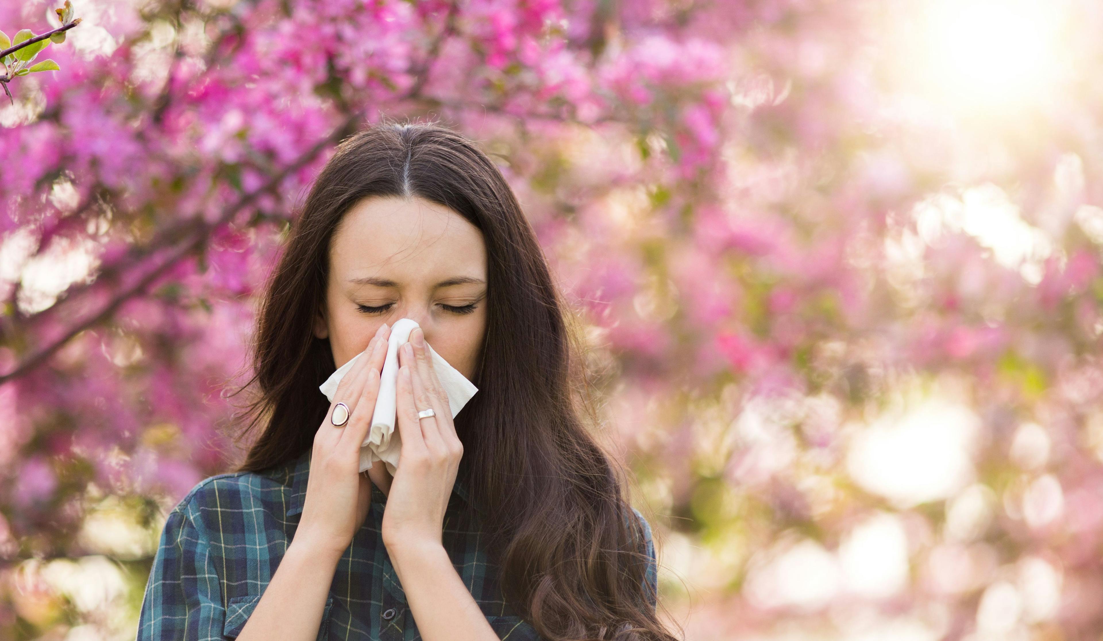 Woman blowing nose because of spring pollen allergy - Image credit: Budimir Jevtic | stock.adobe.com