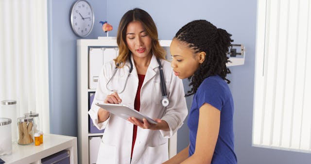 patient explaining issues to doctor using tablet - Image credit: rocketclips | stock.adobe.com