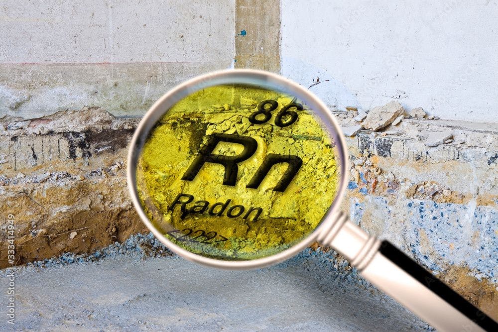Preparatory stage for the construction of a ventilated crawl space in an old brick building - Searching gas radon concept image seen through a magnifying glass - Image credit: Francesco Scatena | stock.adobe.com