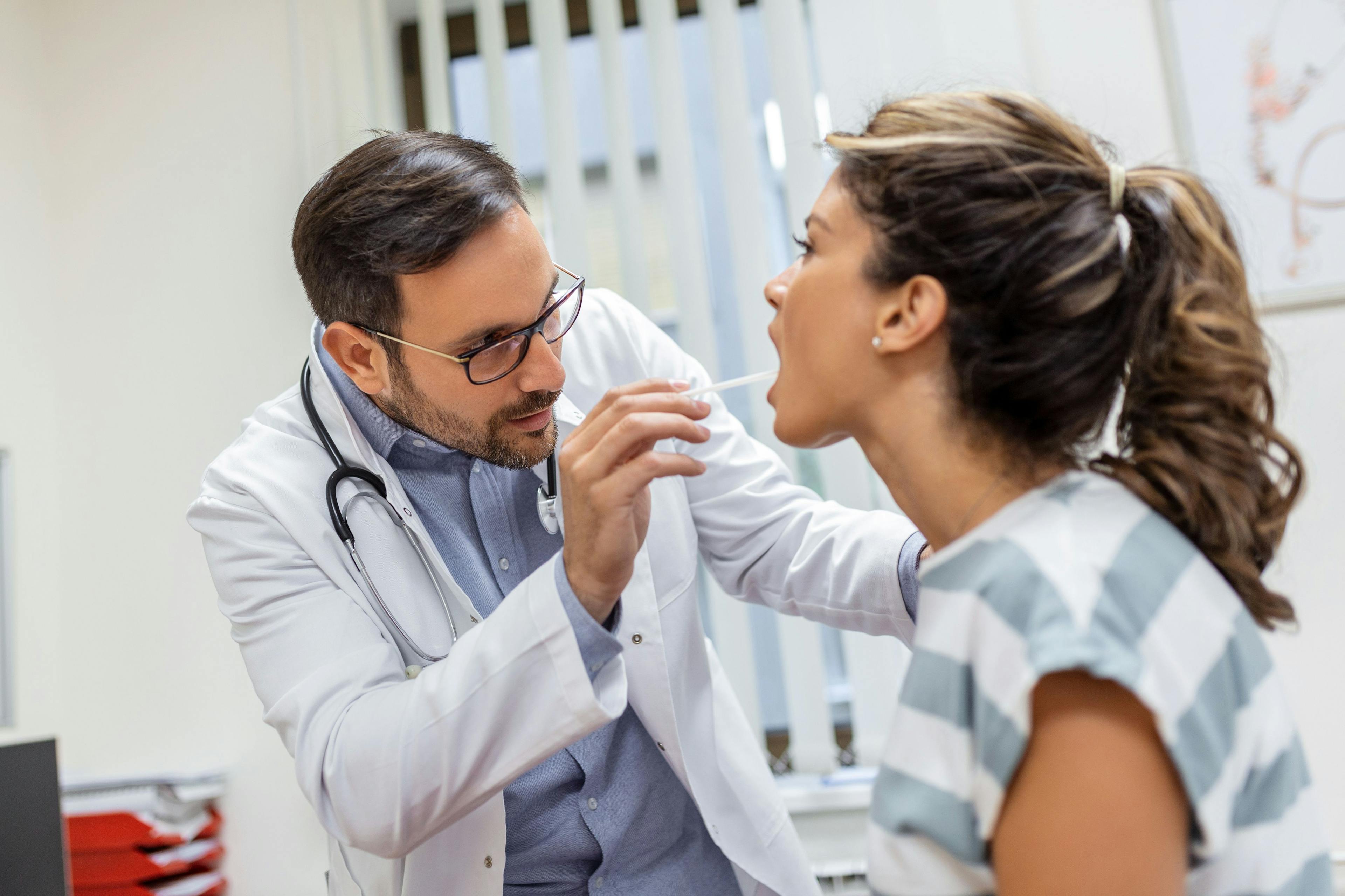 Physician checking a patient's throat