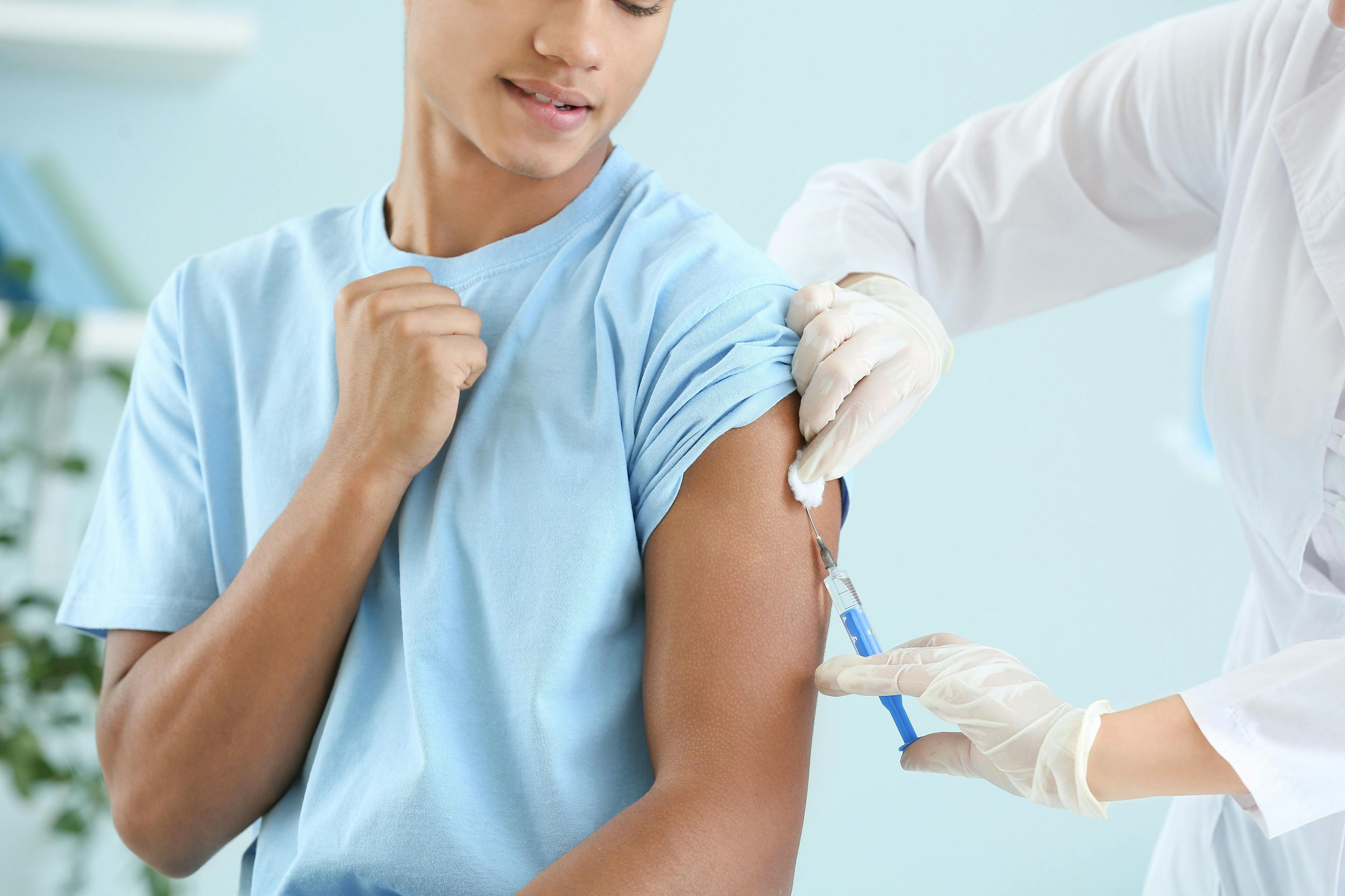 Doctor vaccinating teenage boy in clinic | Image credit: Pixel-Shot - stock.adobe.com