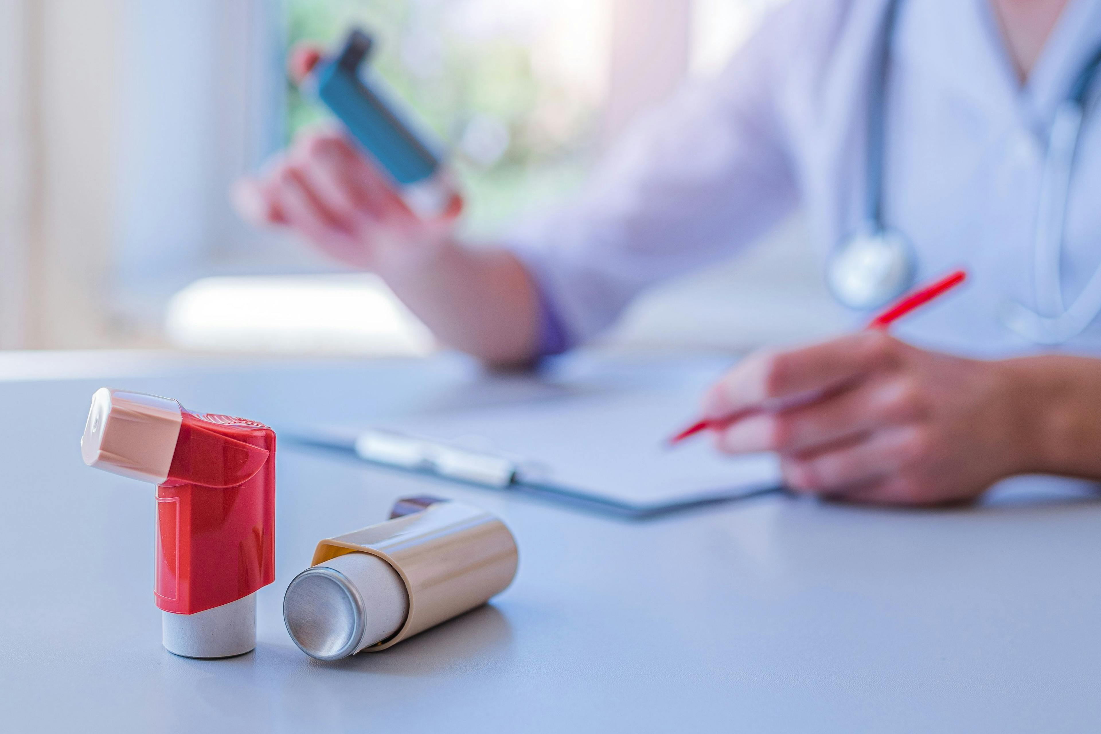 Physician writes prescription for asthma inhaler