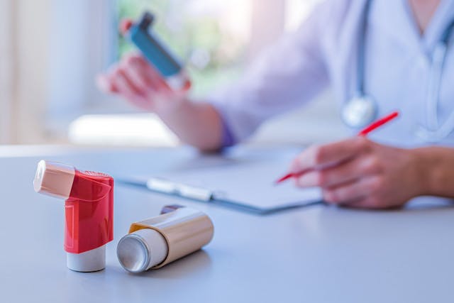 Physician prescribing asthma inhaler -- Image credit: Goffkein | stock.adobe.com