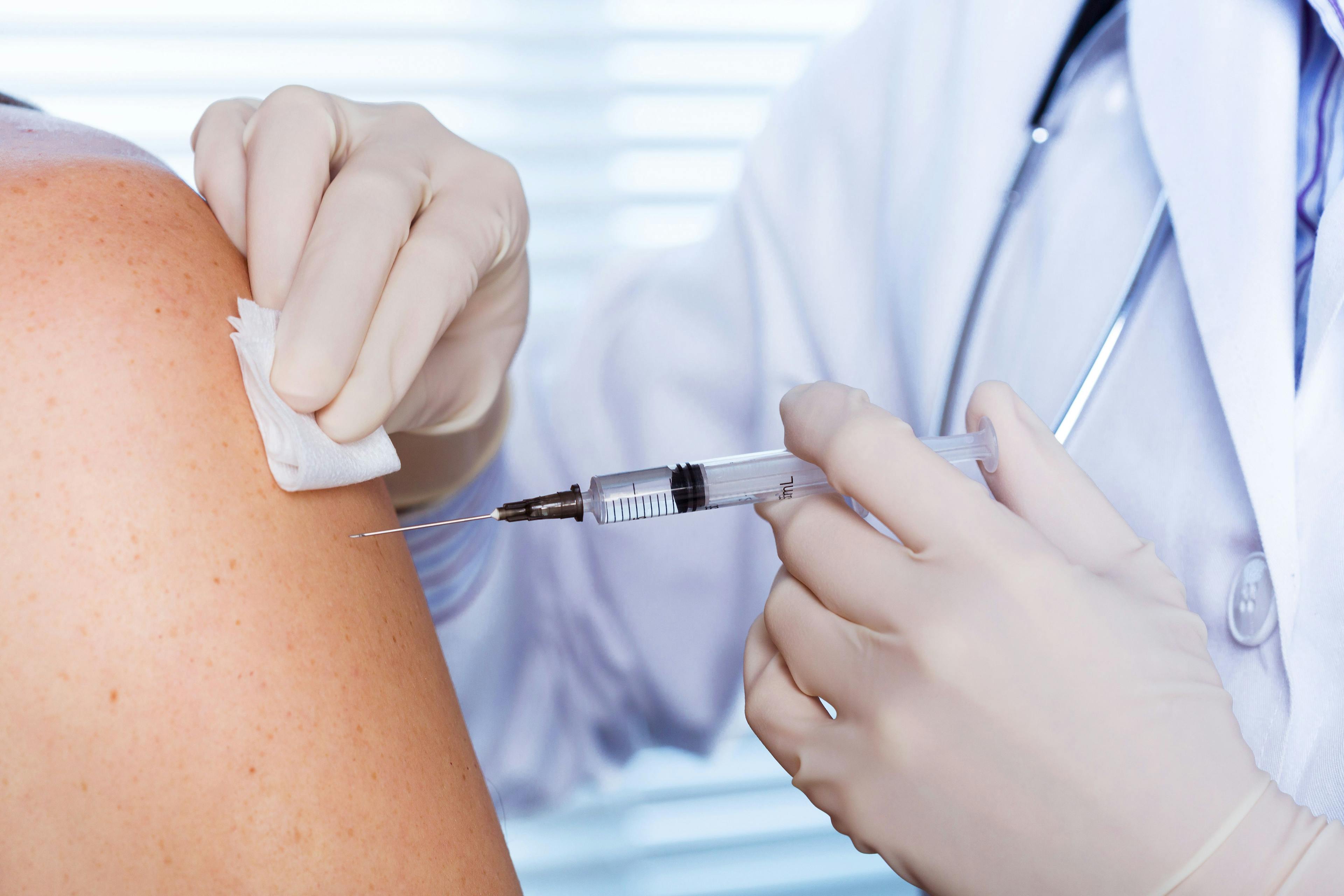 Doctor administering flu vaccination
