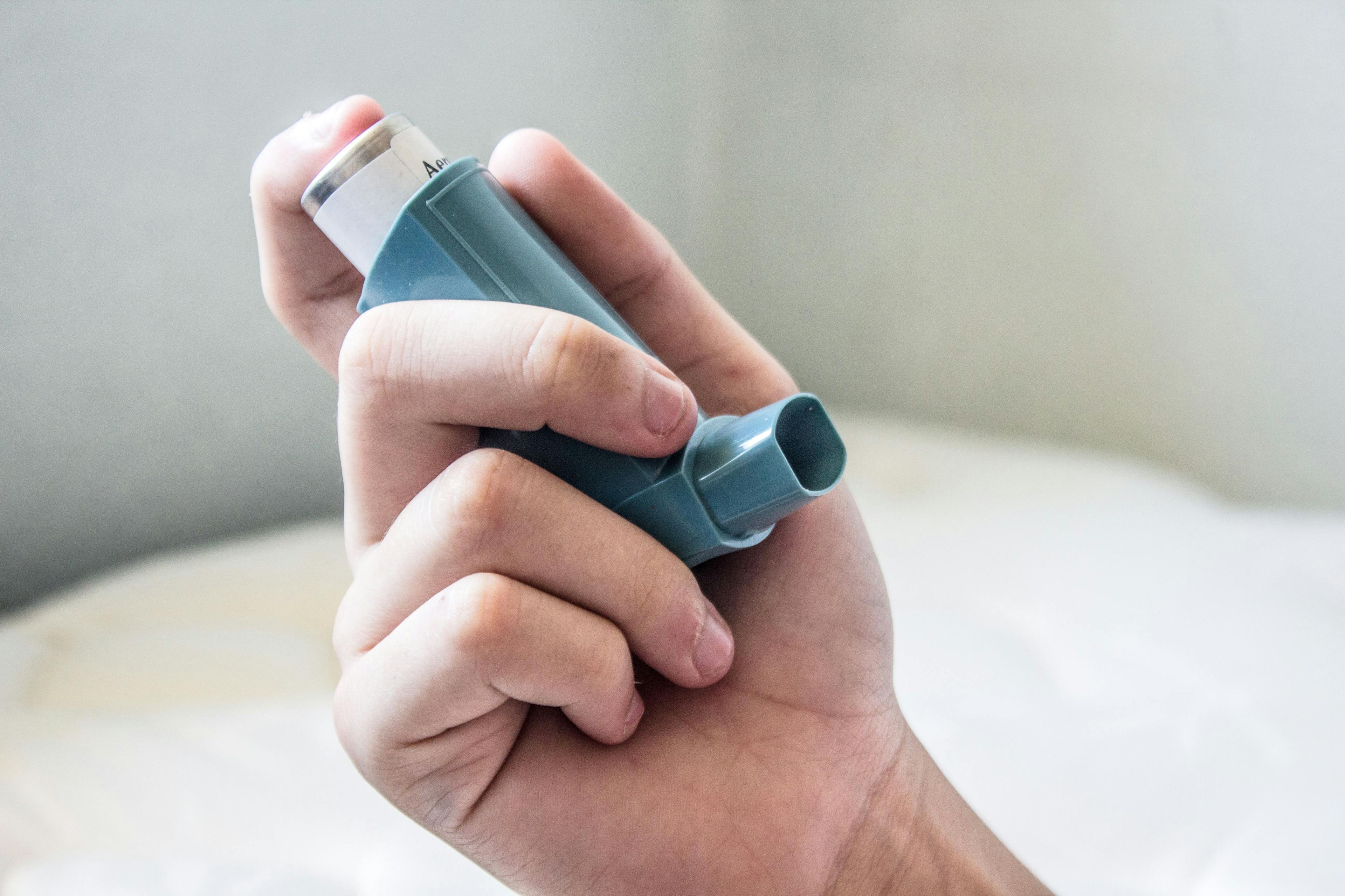 Man holding asthma inhaler
