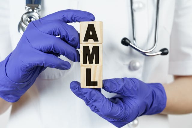 Health care worker holding wooden cubes with AML written -- Image credit: Dzmitry | stock.adobe.com