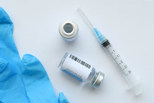 A syringe needle with generic vaccine booster in vial with blank label - mock up copy space - Image credit: MargJohnsonVA | stock.adobe.com