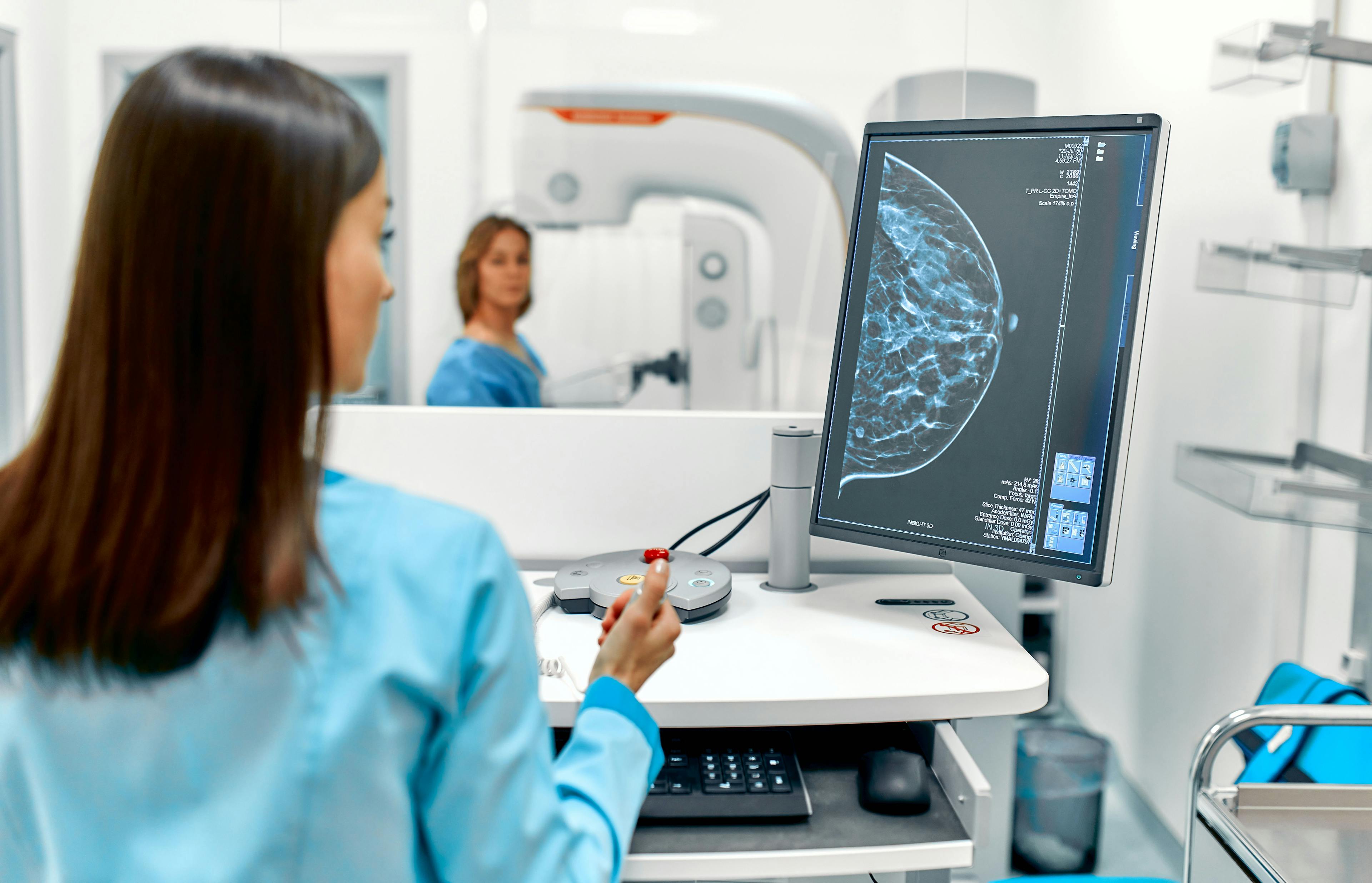 Health care worker looking at a mammogram