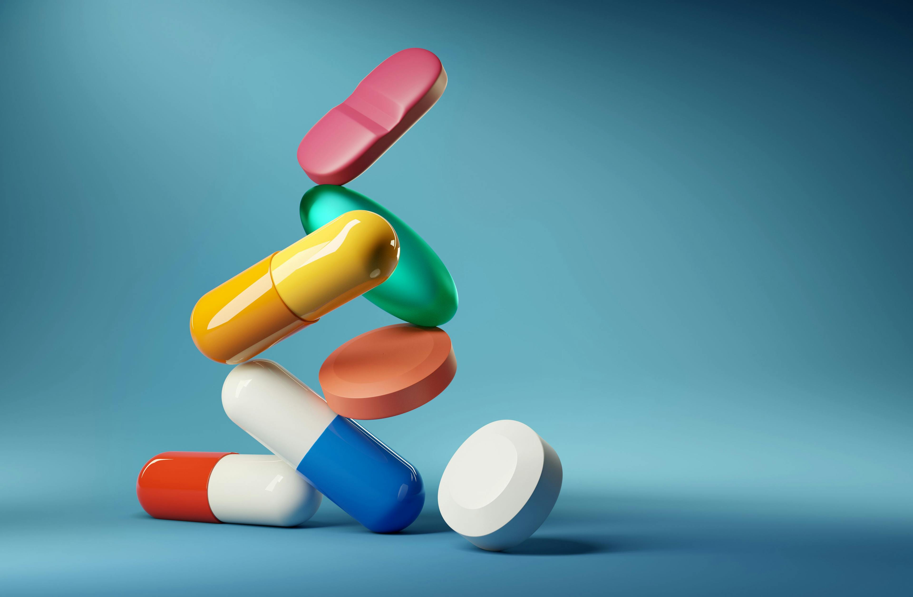 Medical balancing act. A group of medicine pills and antibiotics balancing on top of each other. 3D render illustration | Image credit: James Thew- stock.adobe.com