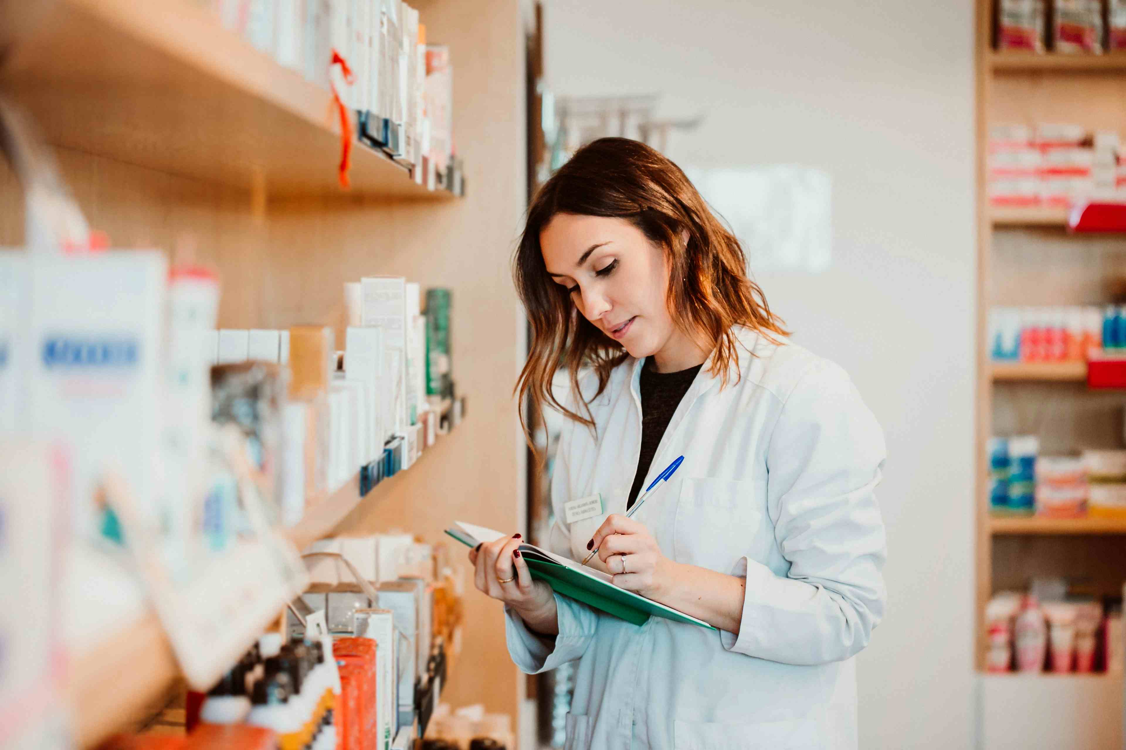 Young female pharmacist working in her large pharmacy. Placing medications, taking inventory. Lifestyle - Image credit: Lubero | stock.adobe.com