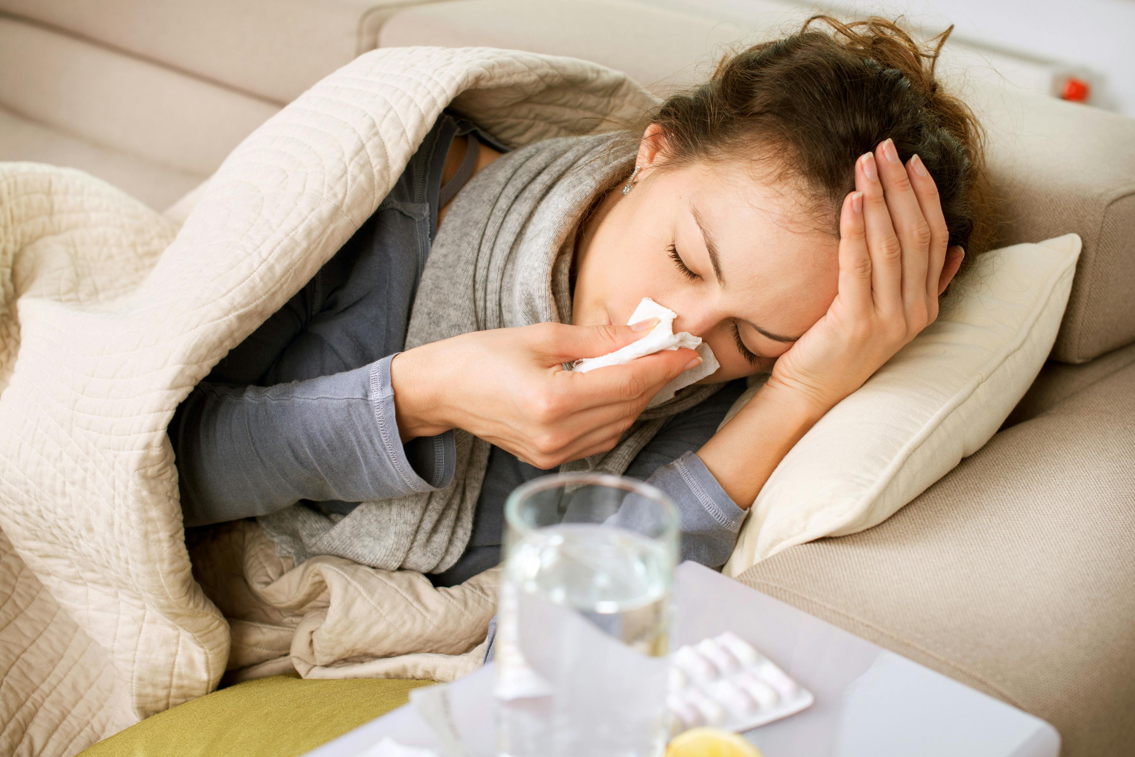 Sick Woman. Flu. Woman Caught Cold. Sneezing into Tissue | Image Credit: Subbotina Anna - stock.adobe.com