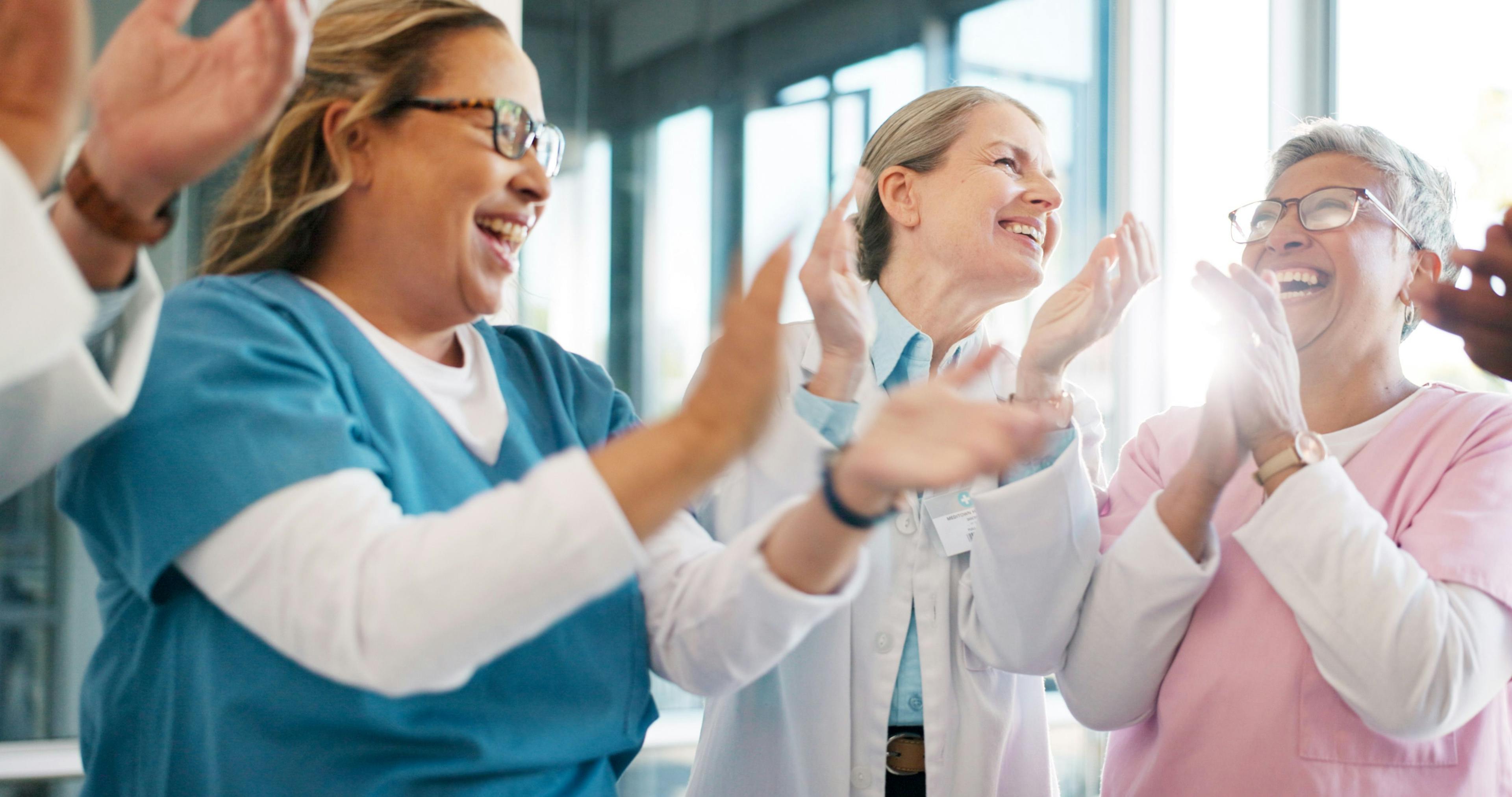 Physicians applauding and supporting team | Image credit: Nina Lawrenson/peopleimages.com - stock.adobe.com