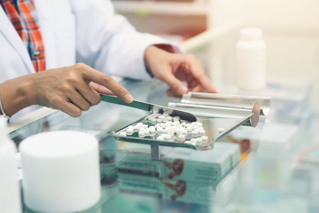 Medicine tablets on counting tray with counting spatula at pharmacy | Image Credit: sutlafk -stock.adobe.com