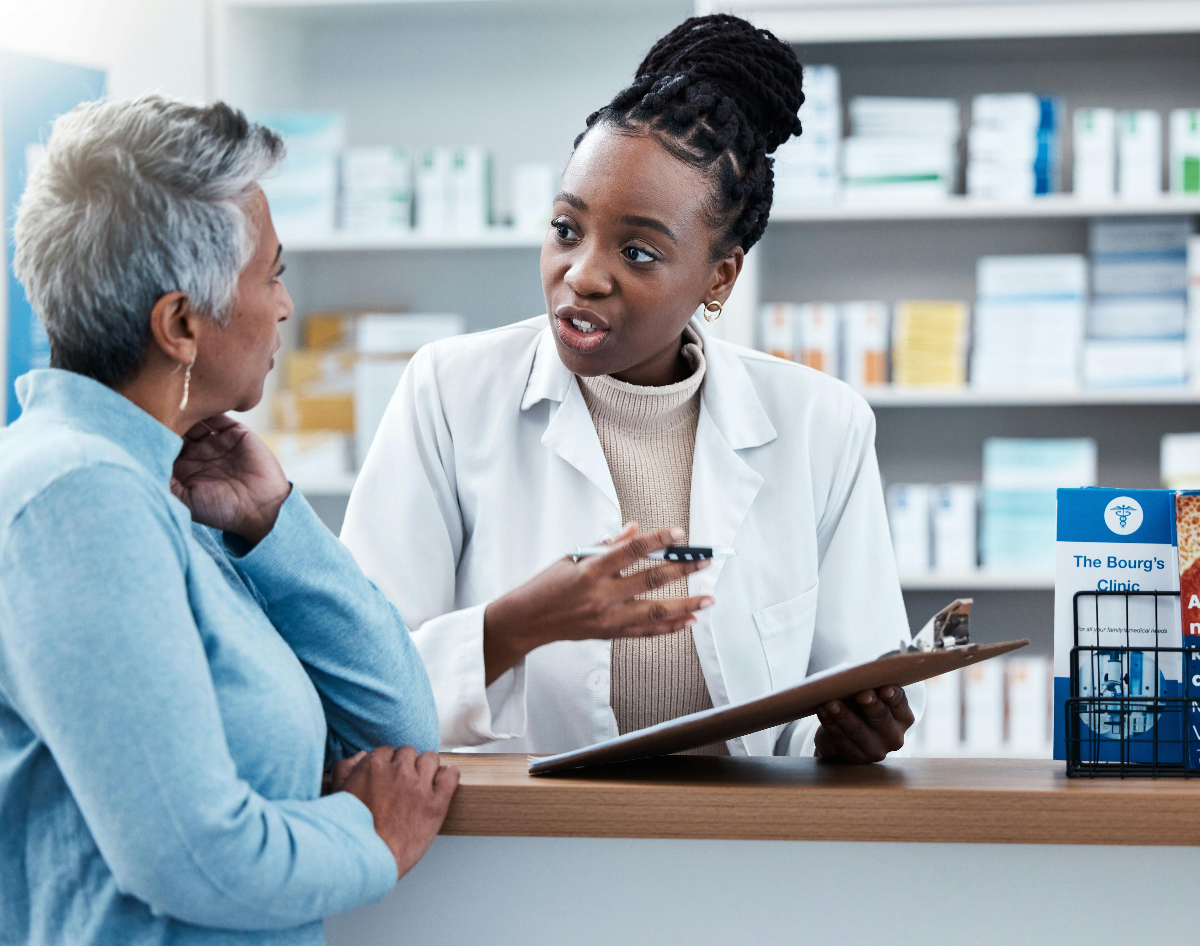 Pharmacy, medical or insurance with a customer and black woman pharmacist in a dispensary. Healthcare, clipboard and trust with a female medicine professional helping a patient in a drugstore - Image credit: Malik E/peopleimages.com | stock.adobe.com