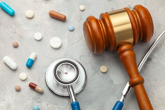 Judge gavel and stethoscope with pills | Image Credit: adragan - stock.adobe.com