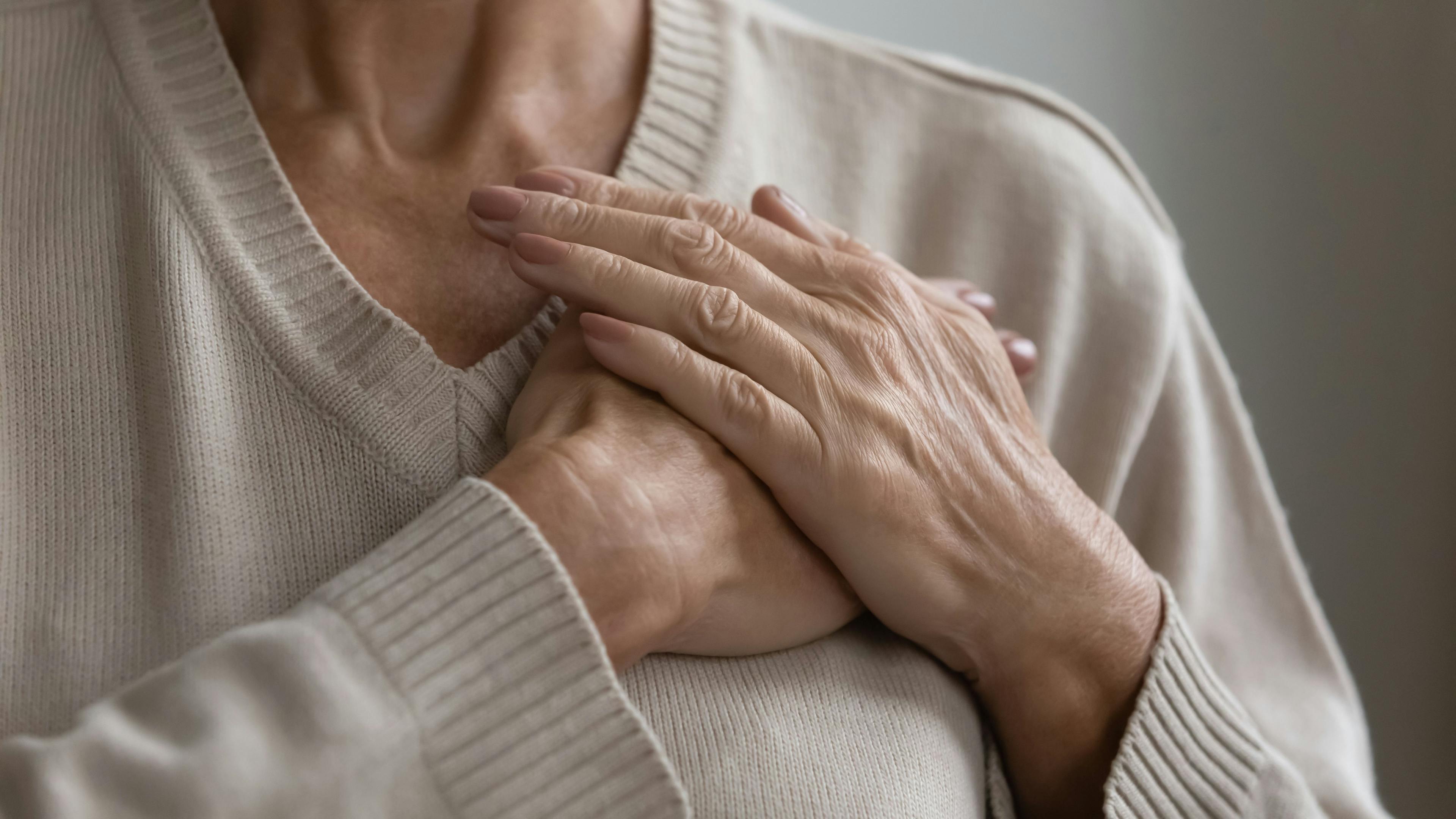 Mature elderly woman feeling heart pain, touching chest with both hands. Thankful senior lady expressing gratitude, love, trust, thanking god, making grateful honor kindness gesture. Close up- Image credit: Fizkes | stock.adobe.com