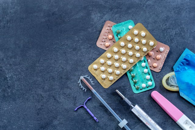 Choosing method of contraception : Birth control pills, an injection syringe, condom, IUD-method, on grey - Image credit: JPC-PROD | stock.adobe.com