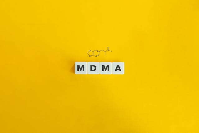 MDMA banner and concept. Block letters on bright orange background. Minimal aesthetics.