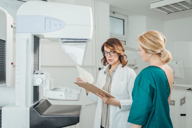 Patient and physician looking at a mammogram