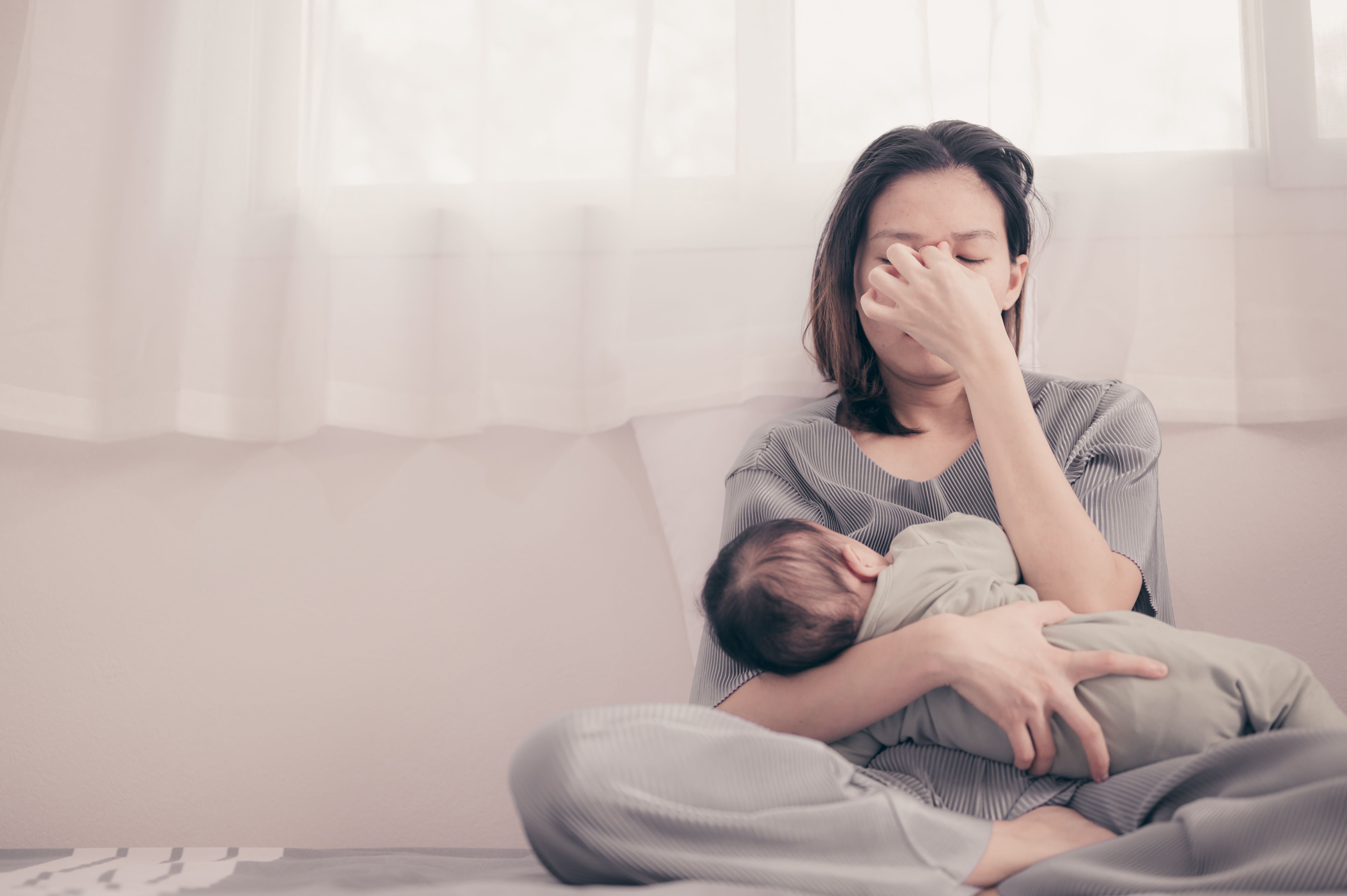 Tired Mother Suffering from experiencing postnatal depression.Health care single mom motherhood stressful. | Image Credit: grooveriderz - stock.adobe.com