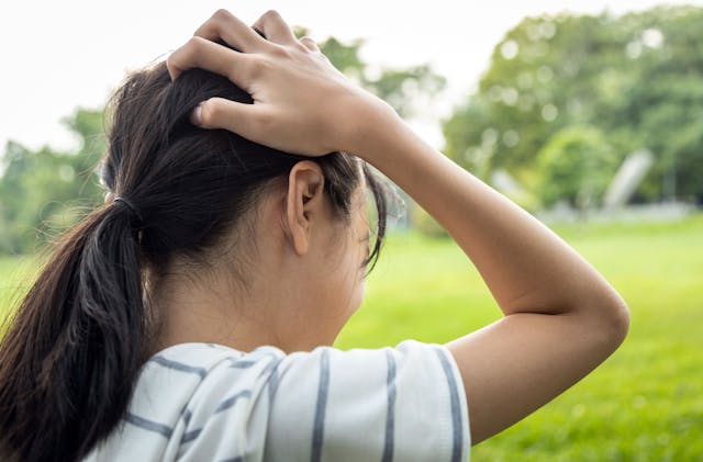 Sick asian child girl holding her painful head, brain cancer,hemorrhagic stroke and tumor inside brain,female teenage person with a severe headache in outdoor park,health problem , health care concept - Image credit: Satjawat | stock.adobe.com