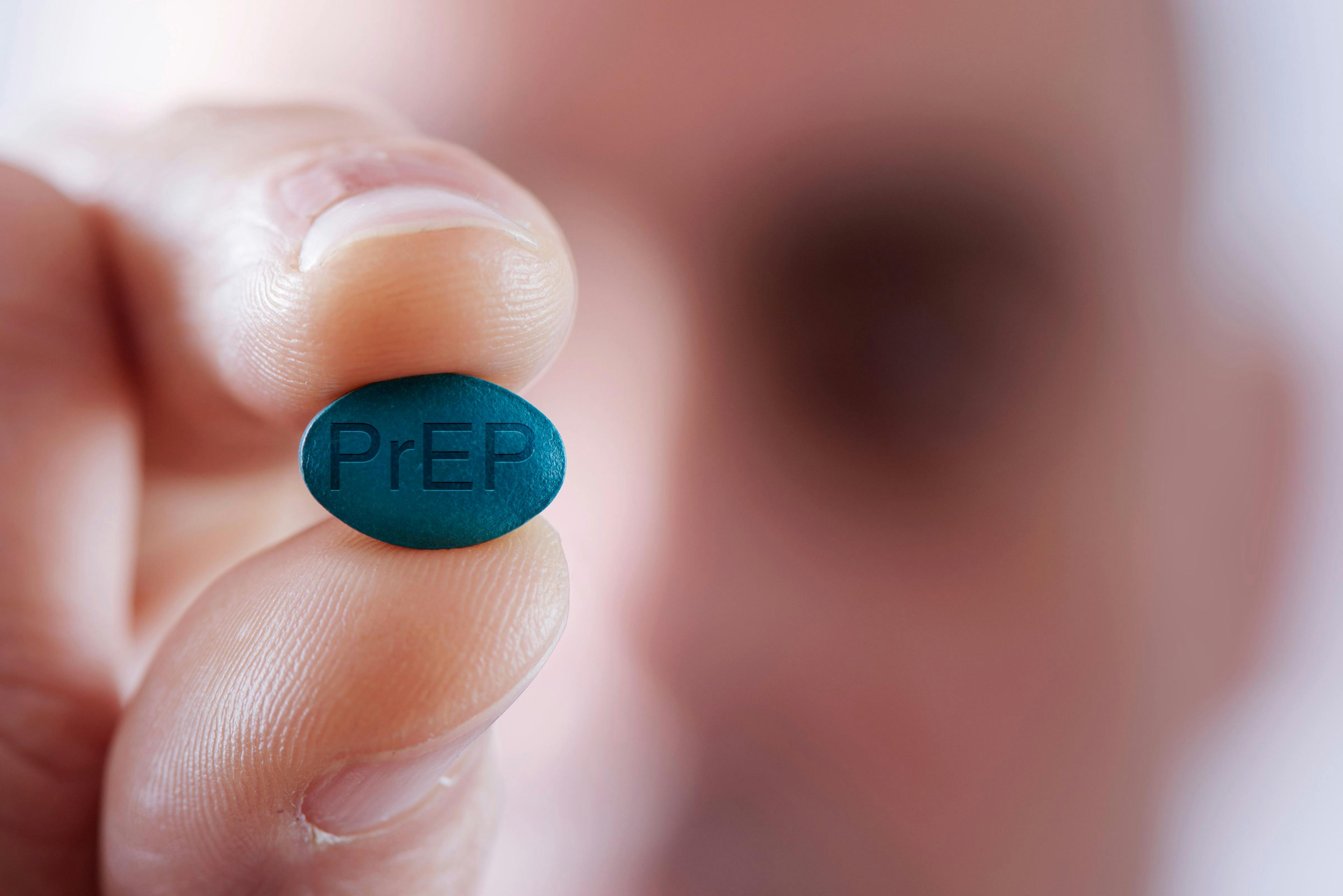 young man with a PrEP pill HIV | Image Credit: nito - stock.adobe.com