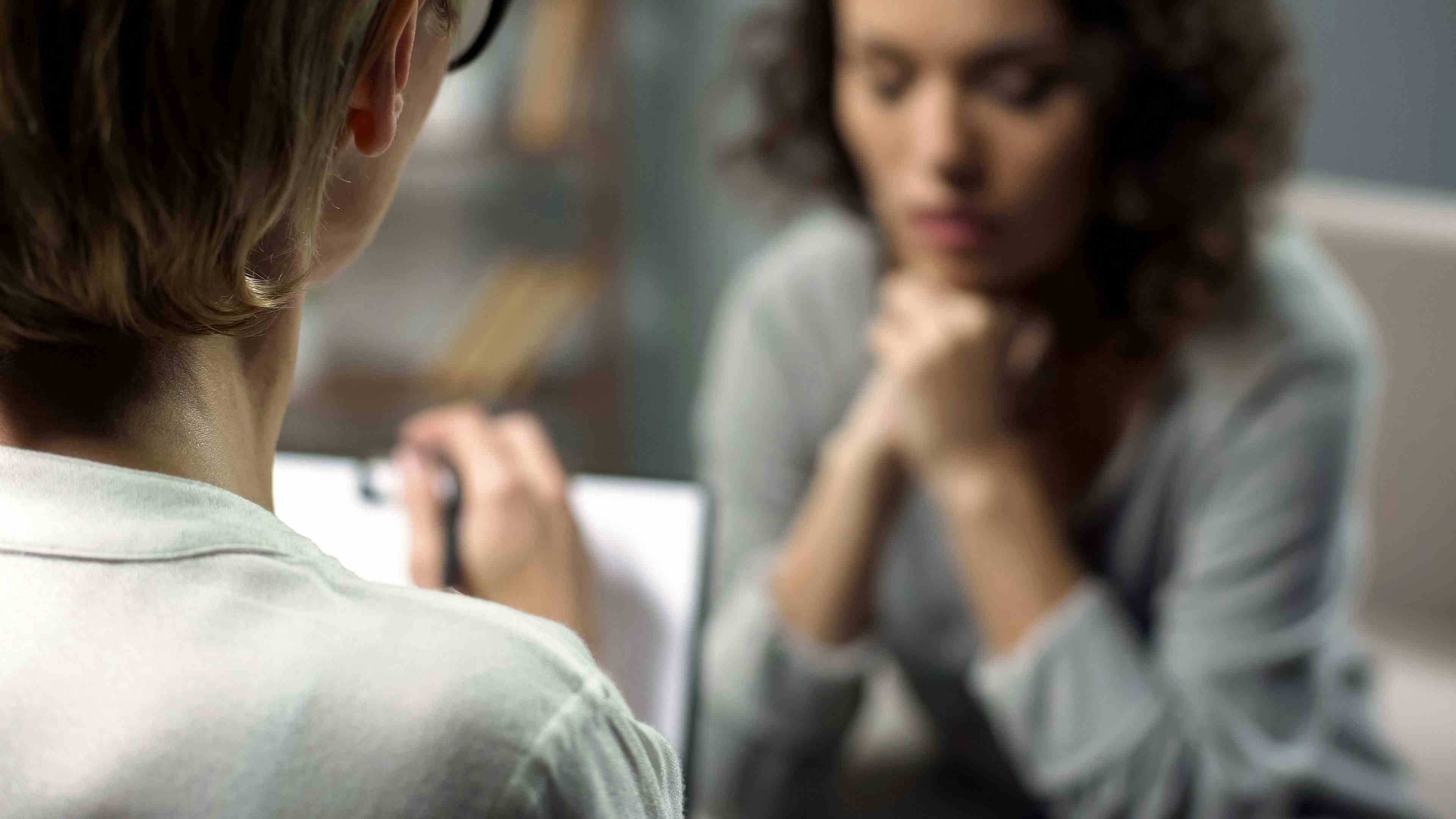 Image credit: motortion | stock.adobe.com - Young depressed woman talking to lady psychologist during session, mental health