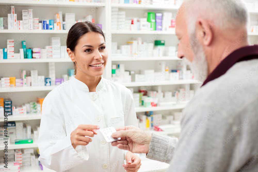 pharmacist selling medications to senior patient | Image Credit: Ivan - stock.adobe.com