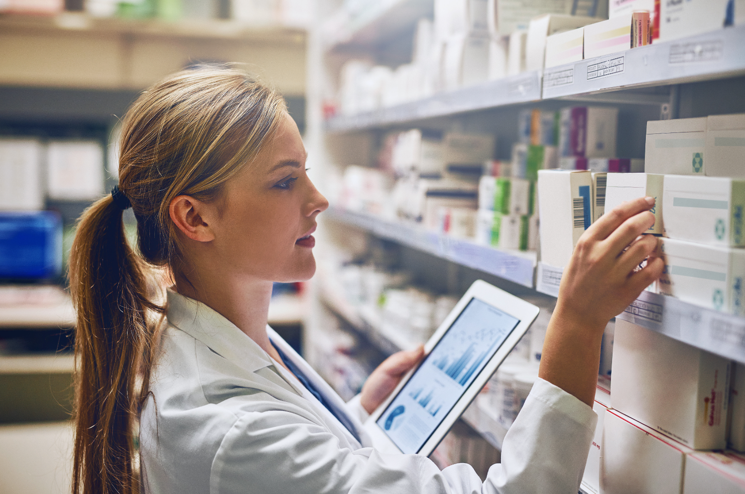 Shot of a pharmacist using her digital tablet while working in aisle. | Image Credit: Nikish Hiraman/peopleimages.com - stock.adobe.com