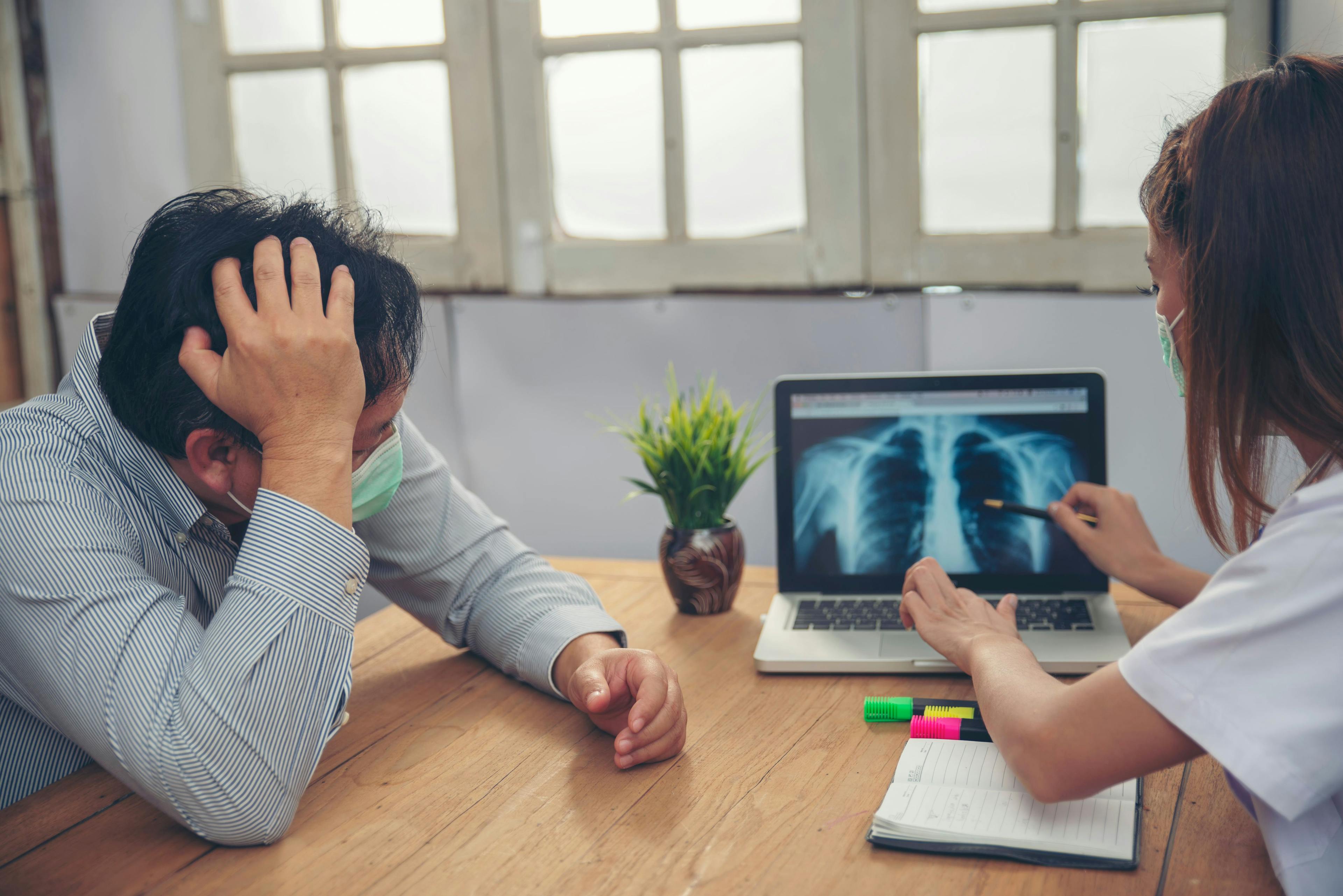 Health care practitioner discussing lung x-ray with a patient