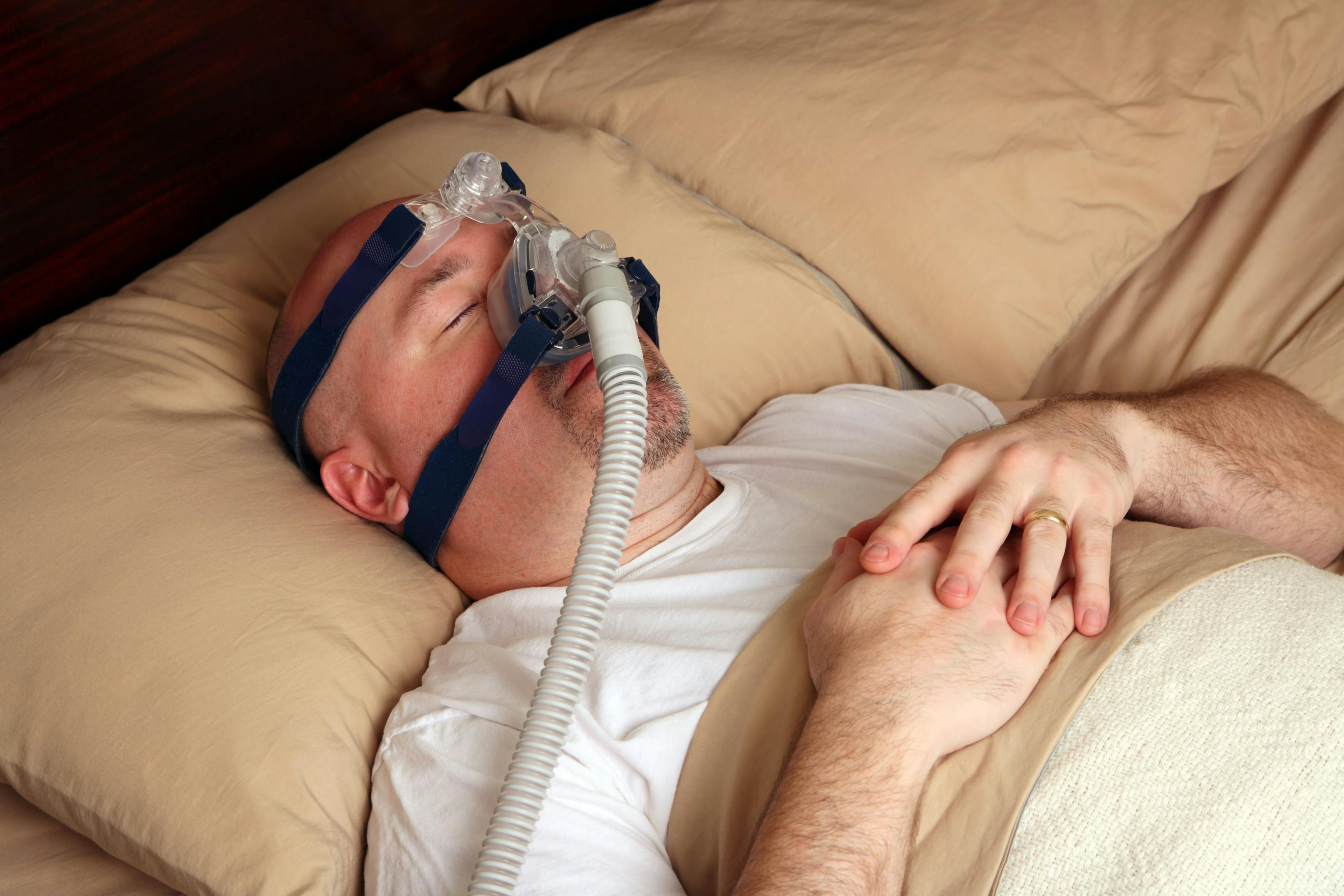  Man with sleep apnea using a CPAP machine in bed. Credit: auremar - stock.adobe.com