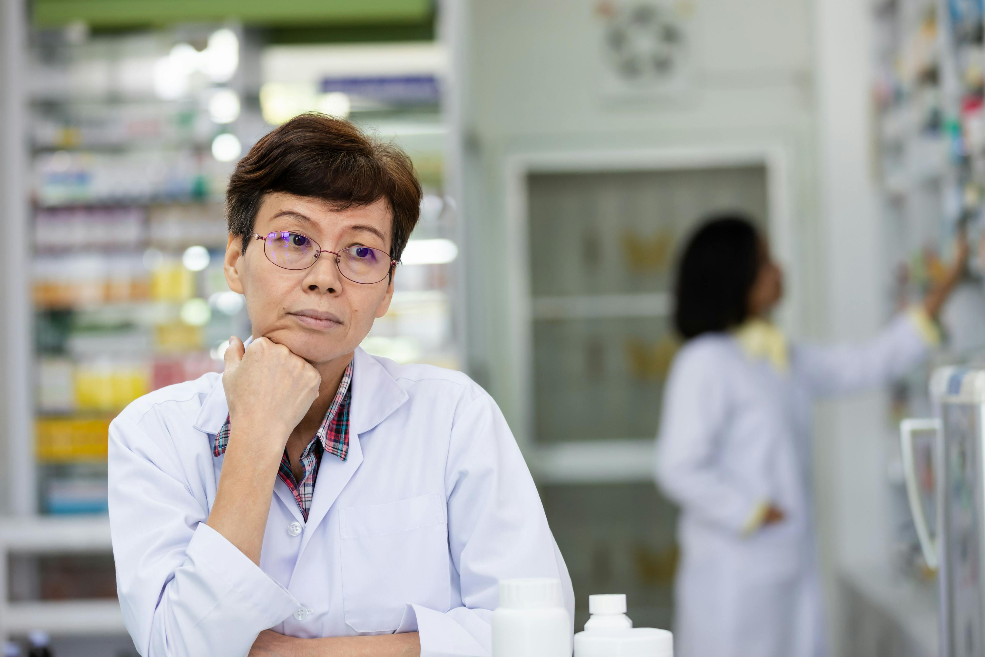 female elderly pharmacist she had problems with depression while working in pharmacy store