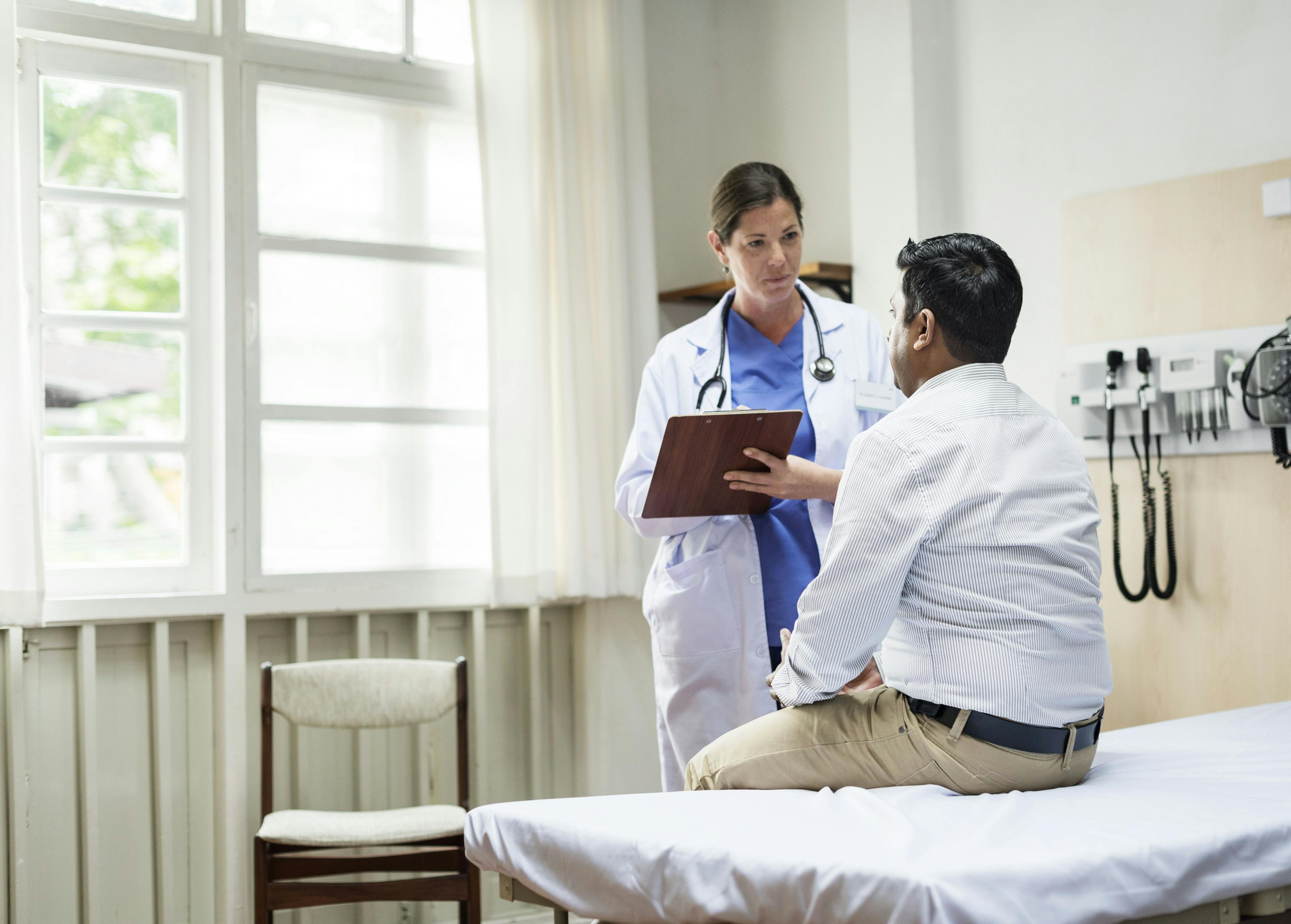 Male patient talking to doctor