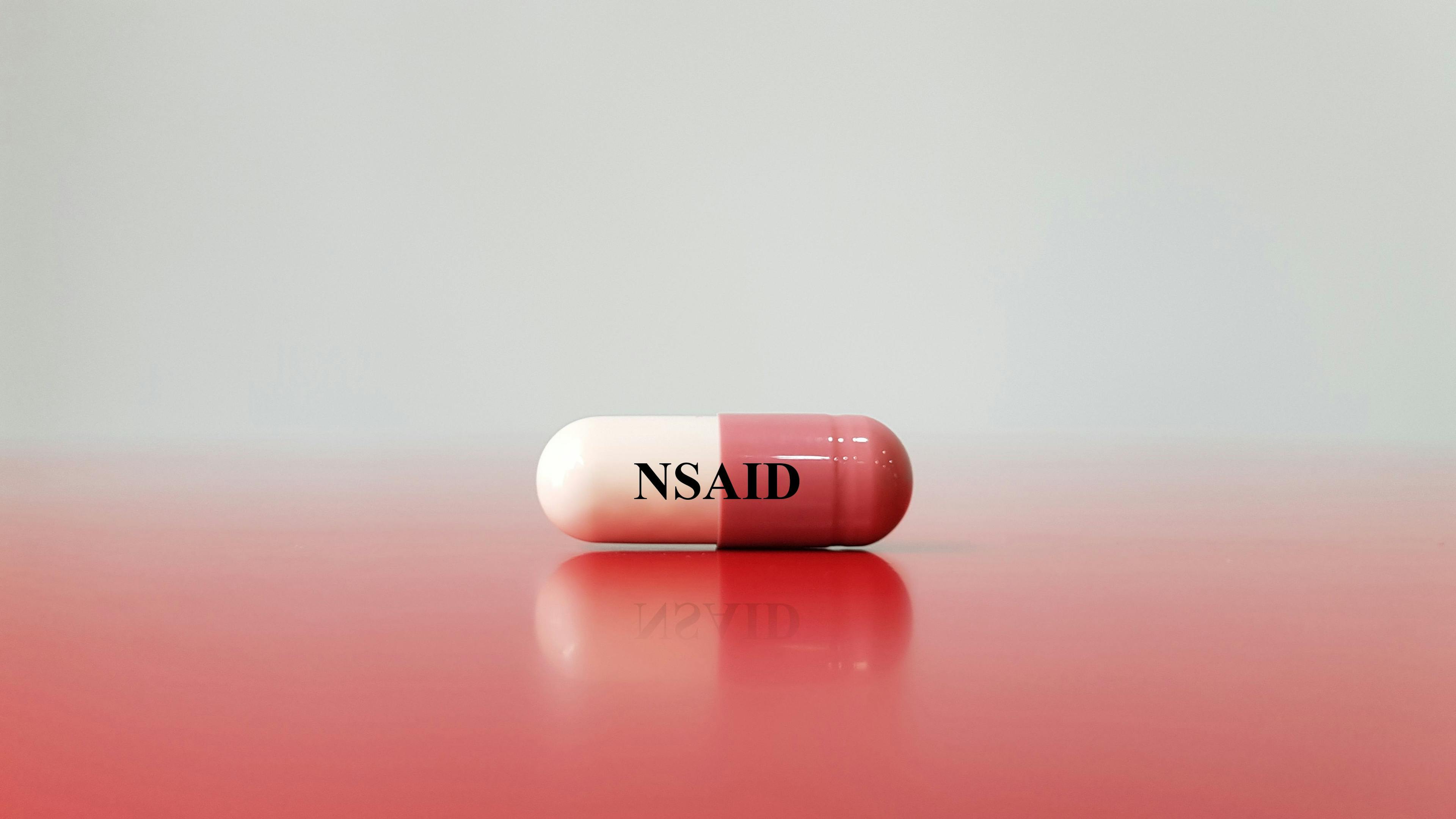 Capsule of NSAID drug on white background(Nonsteroidal anti-inflammatory drug). This medication used for pain control, decrease inflammation, fever treatment, prevent blood clot. Medical concept  | Image credit: Joel bubble ben - stock.adobe.com