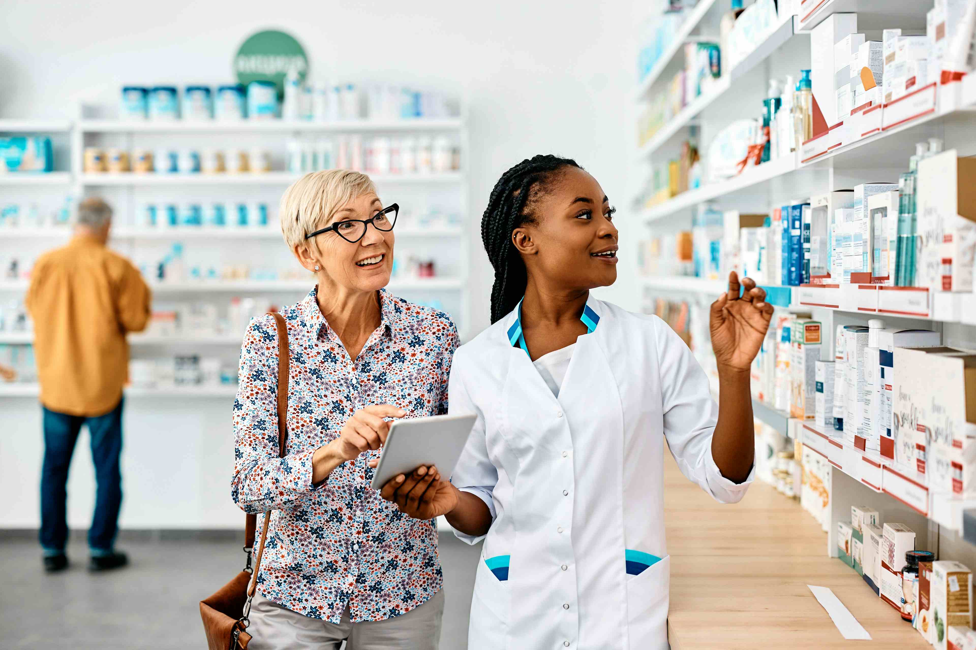 Pharmacist assists senior woman in buying medicine in pharmacy - Image credit: Drazen | stock.adobe.com