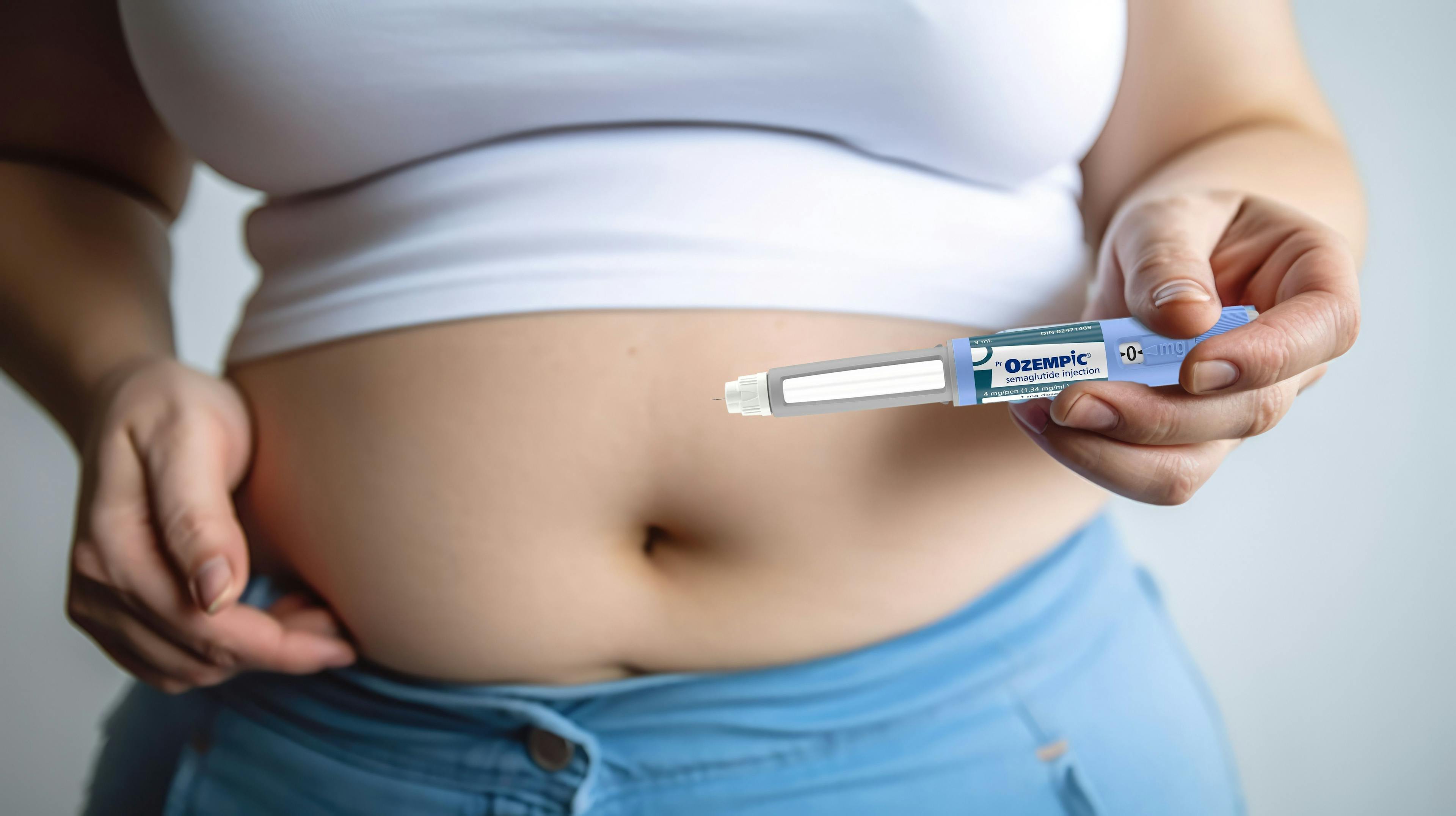 Ozempic Semaglutide Injection Diabetes Drug Being Used For Weight Loss. A Woman Holding an Ozempic Injection Pen in Front of Her Stomach.