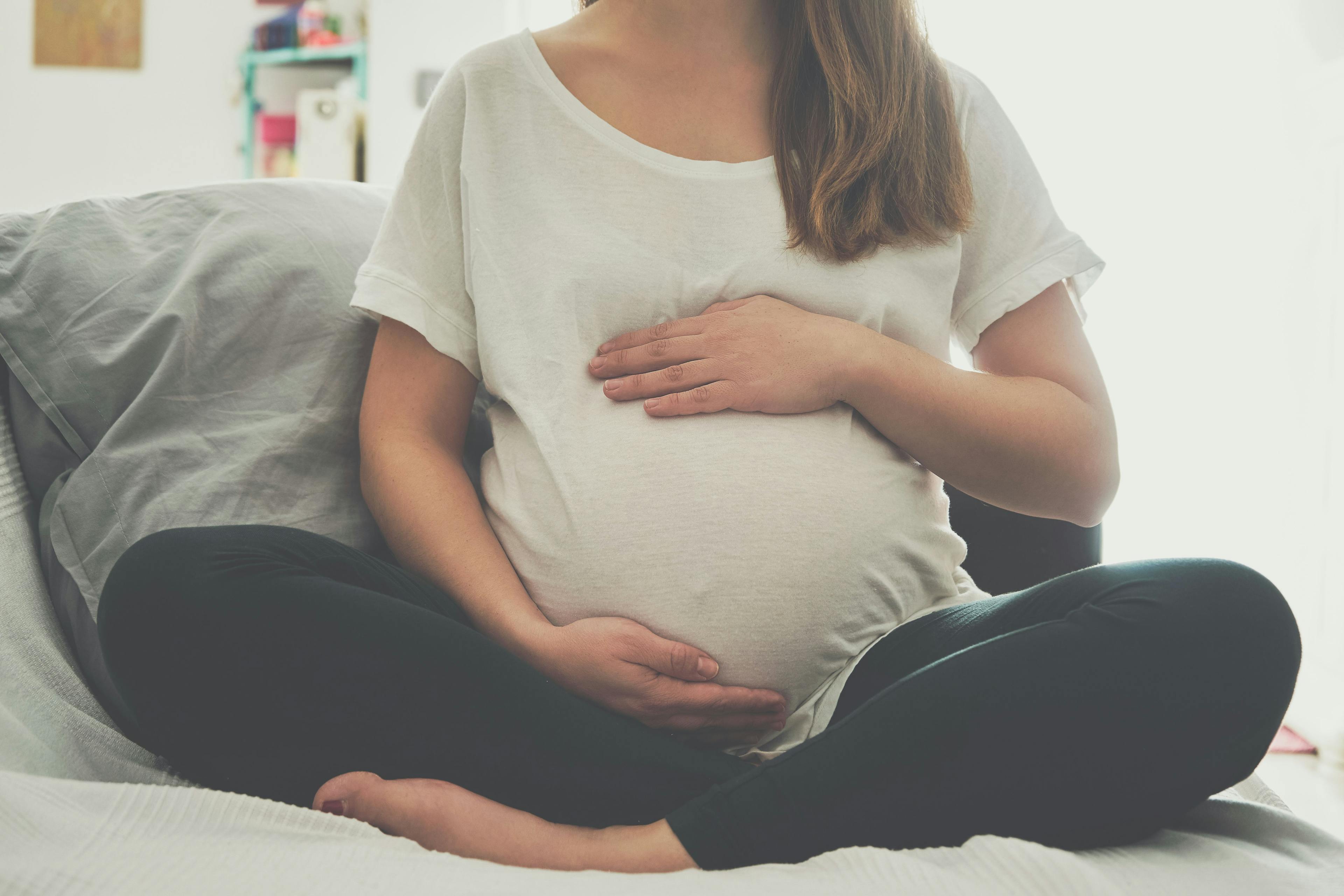 Pregnant woman touching her belly | Image Credit: SianStock - stock.adobe.com